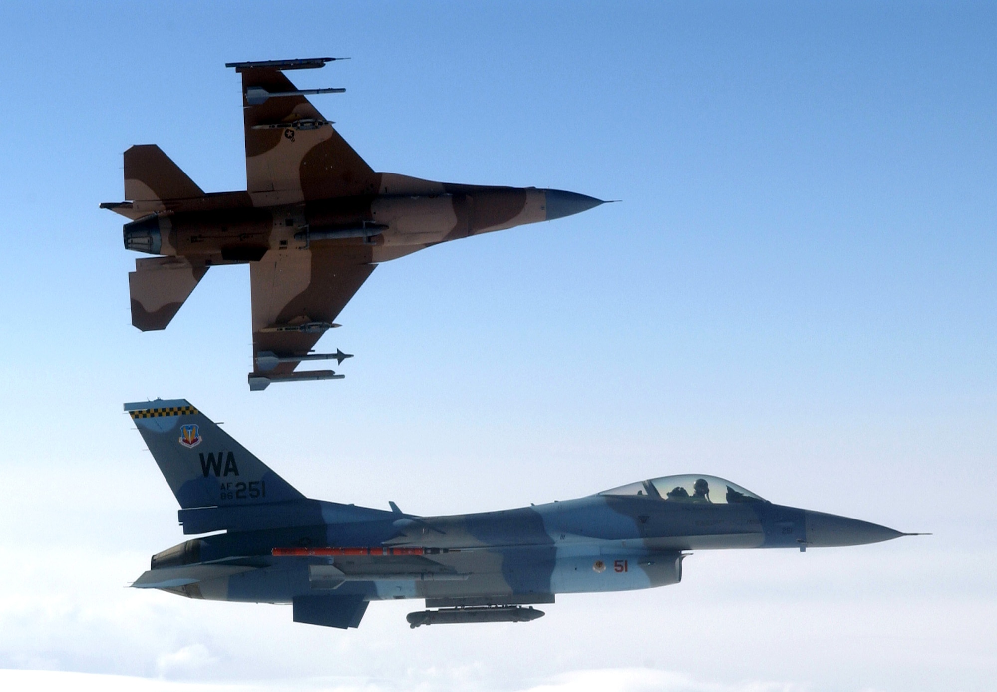 Two of three Aggressor paint schemes are displayed on F-16 Fighting Falcons participating in Red Flag-Alaska at Eielson Air Force Base, Alaska, on Thursday, May 4, 2006. The F-16s are from the 64th Aggressor Squadron at Nellis AFB, Nev. (U.S. Air Force photo/Master Sgt. Rob Wieland) 