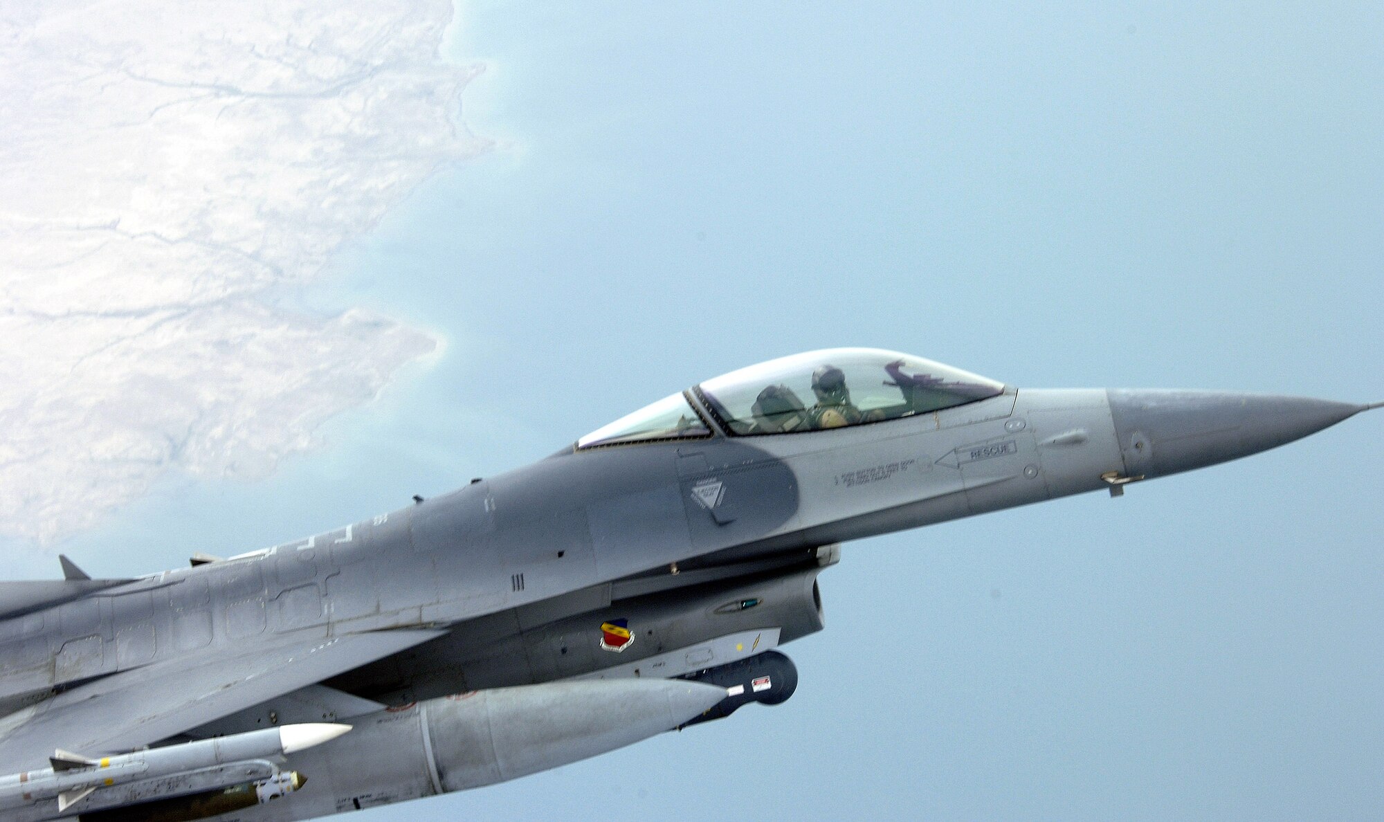 An F-16 Fighting Falcon continues its close-air -support mission over Iraq after refueling with a KC-135 Stratotanker on Sunday, May 7, 2006. The KC-135 is from the 340th Expeditionary Air Refueling Squadron in Southwest Asia. The F-16 is deployed from Hill Air Force Base, Utah, to Balad Air Base, Iraq. (U.S. Air Force photo/Senior Airman Brian Ferguson)