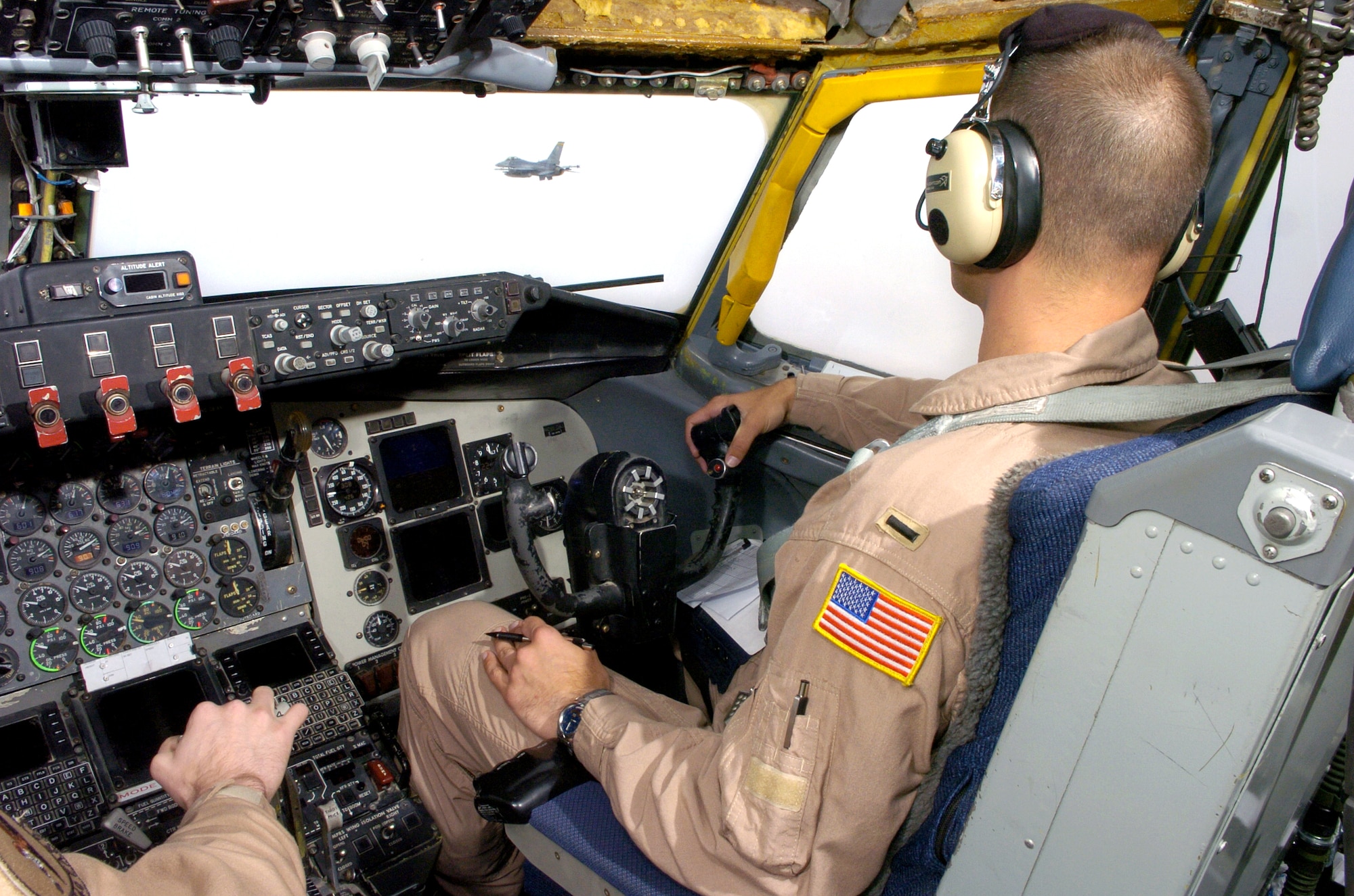 An F-16 Fighting Falcon flies past the window of 1st Lt. Justin Hargrove on Sunday, May 7, 2006, over Iraq. After refueling with the KC-135 Stratotanker, the F-16 continued its close-air-support mission over Iraq. Lieutenant Hargrove is deployed to the 340th Expeditionary Air Refueling Squadron in Southwest Asia from McConnell Air Force Base, Kan. (U.S. Air Force photo/Senior Airman Brian Ferguson)