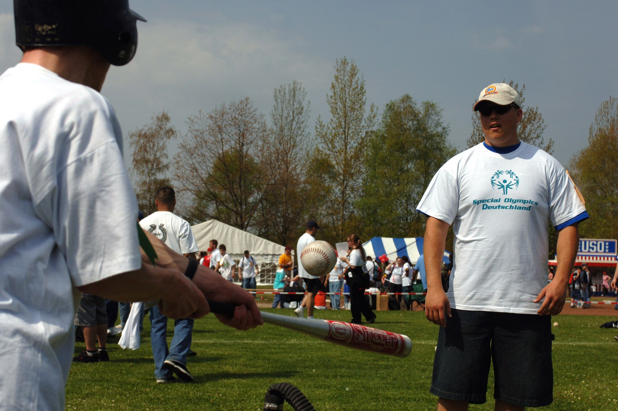 Senior Airman Sean Rabbie watches a Special Olympics athlete connect with a baseball at Enkenbach-Alsenborn, Germany, on Wednesday, May 3, 2006. This is the 29th time the games were held in this part of Germany. Volunteers usually outnumber the athletes. Airman Rabbie is with the 435th Communications Squadron at Ramstein Air Base, Germany. (U.S. Air Force photo/Master Sgt. John E. Lasky)
