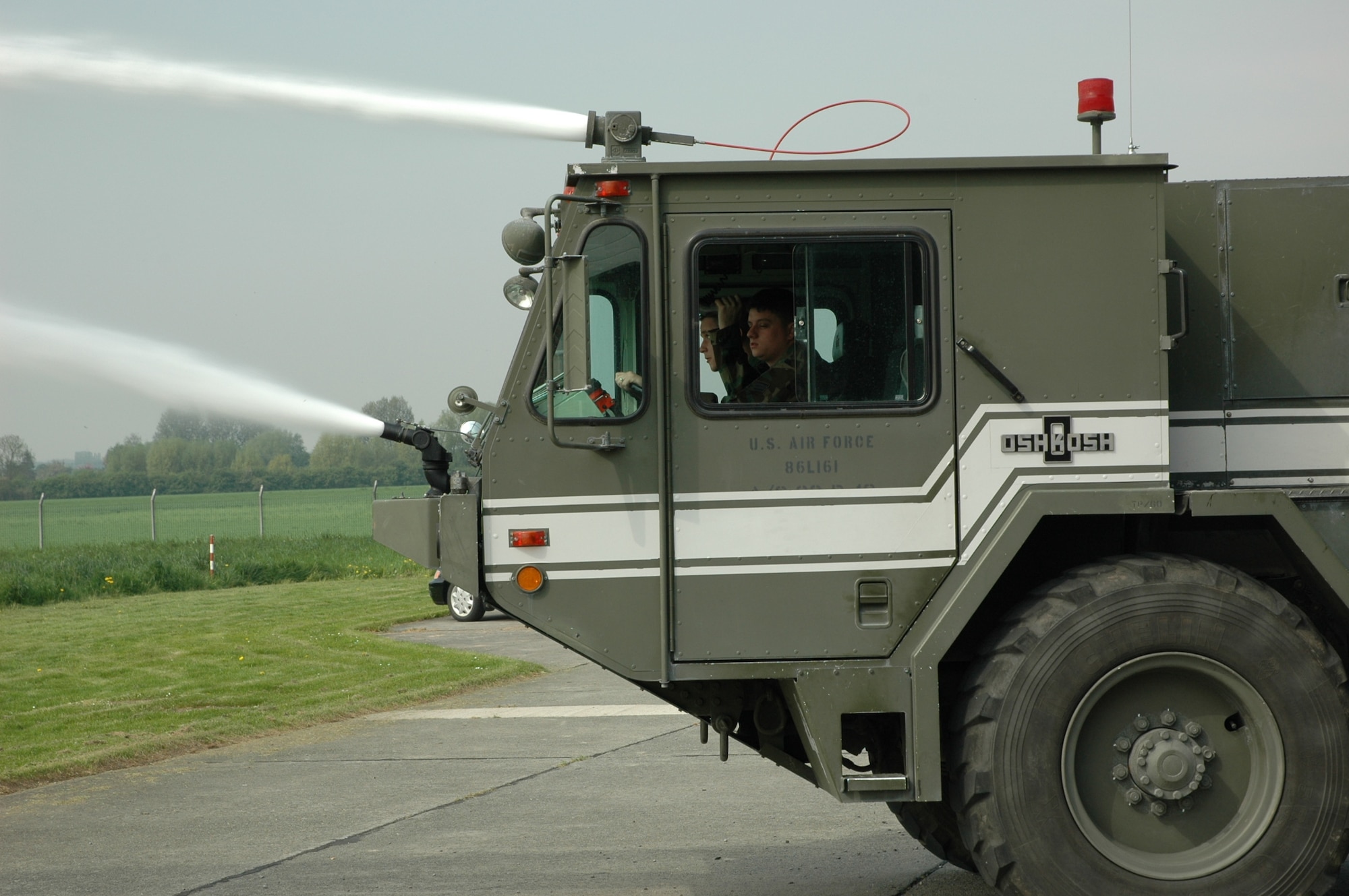 CHIEVRES AIR BASE, Belgium (USAFENS) --Senior Airman Bradley Fear (front) and Staff Sgt. Nathan Ahl conduct an operational check of the pump and turrets on a P-19 Airport Rescue Fire Fighting vehicle. (Photo by 1st Lt. Elizabeth Culbertson)