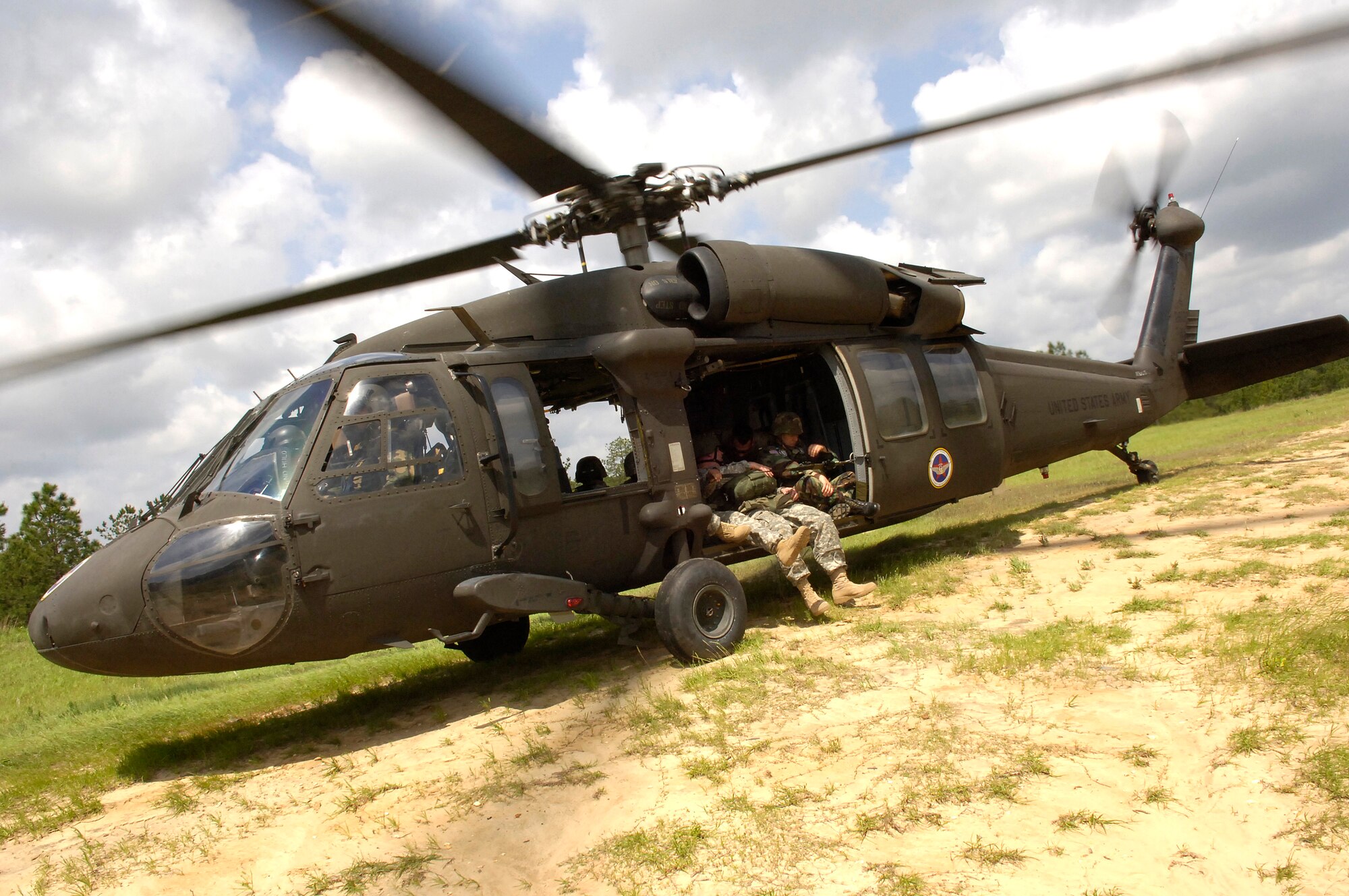 An Army UH-60 Blackhawk waits to take off from drop zone "Geronimo," located at the Joint Readiness Training Center at Fort Polk, La., on Wednesday, May 3, 2006. Special operations Soldiers, along with an Air Force survival, evasion, resistance and escape specialist, completed static-line parachute training. (U.S. Air Force photo/Senior Airman Stephen J. Otero)