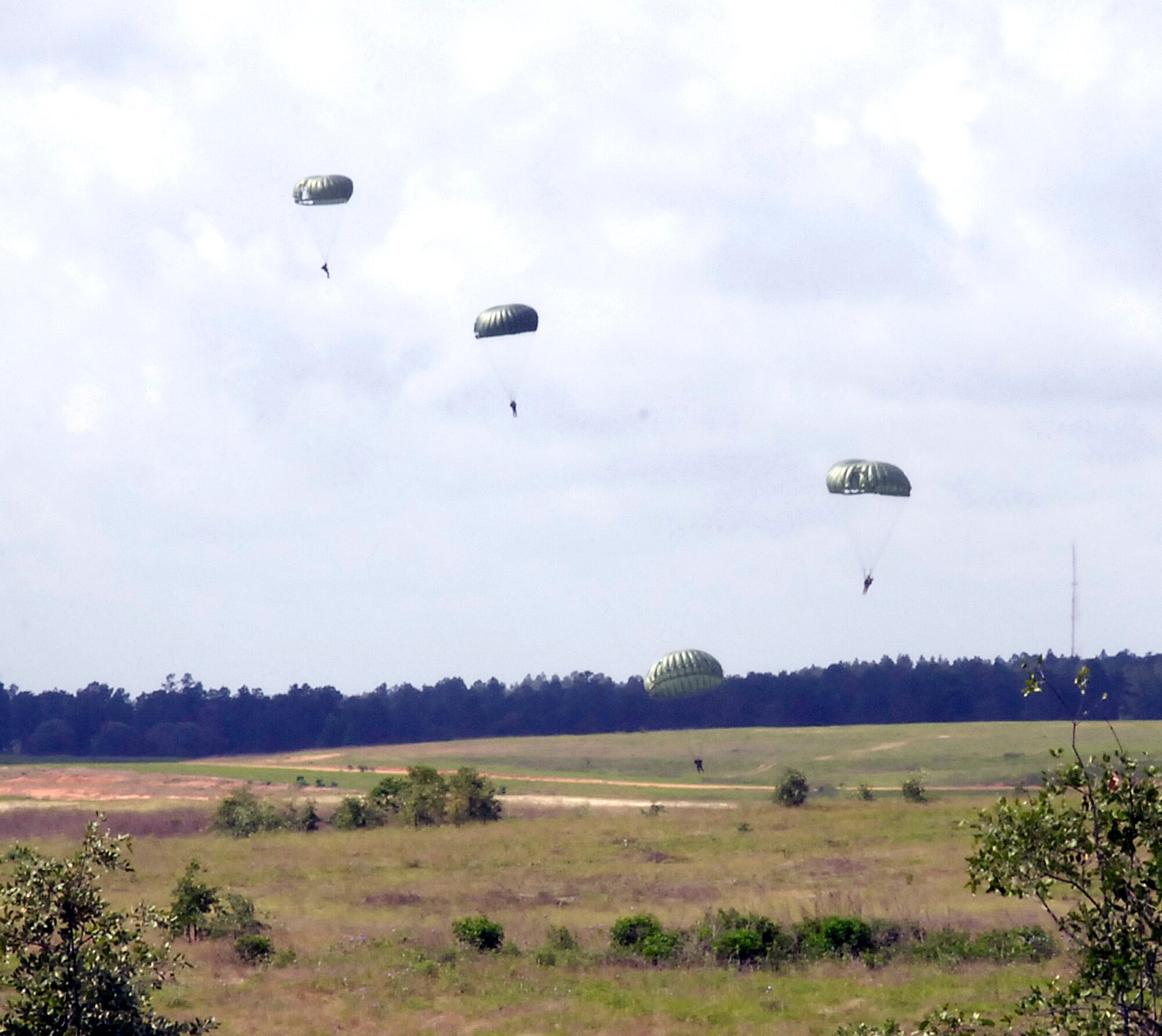 Special operations Soldiers prepare to land during static-line parachute training at the Joint Readiness Training Center at Fort Polk, La., on Wednesday, May 3, 2006. They were joined by an Air Force survival, evasion, resistance and escape specialist. (U.S. Air Force photo/Senior Airman Stephen J. Otero) 
