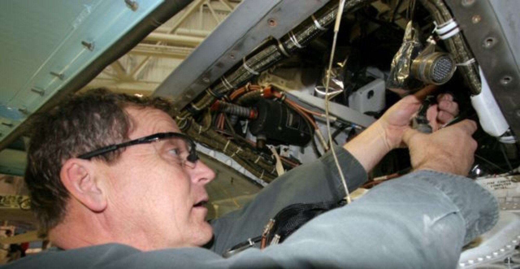 HILL AIR FORCE BASE, Utah - Terry Johansen, an aircraft electrician with the 309th Aircraft Maintenance Group at Hill AFB, terminates a plug in the aft equipment bay. (Photos by G. A. Volb)