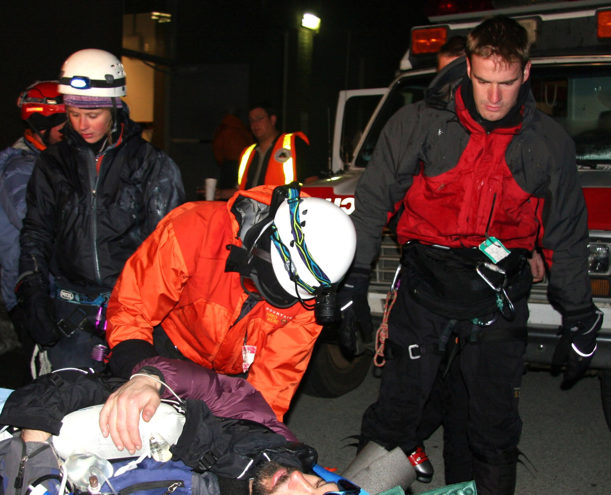 Tech. Sgt. Kevin Baum (center) and Staff Sgt Josiah Blanton (right) help move a patient to an ambulance for transport to a hospital on Saturday, May 6, 2006. The pararescuemen from the Air Force Reserve Command's 304th Rescue Squadron were part of a 15-member rescue team. They helped rescue a skier who had fallen more than 300 feet on Mount Hood, Ore. The 304th RQS is in Portland, Ore. (U.S. Air Force Photo/Master Sgt. Ruby Zarzyczny)