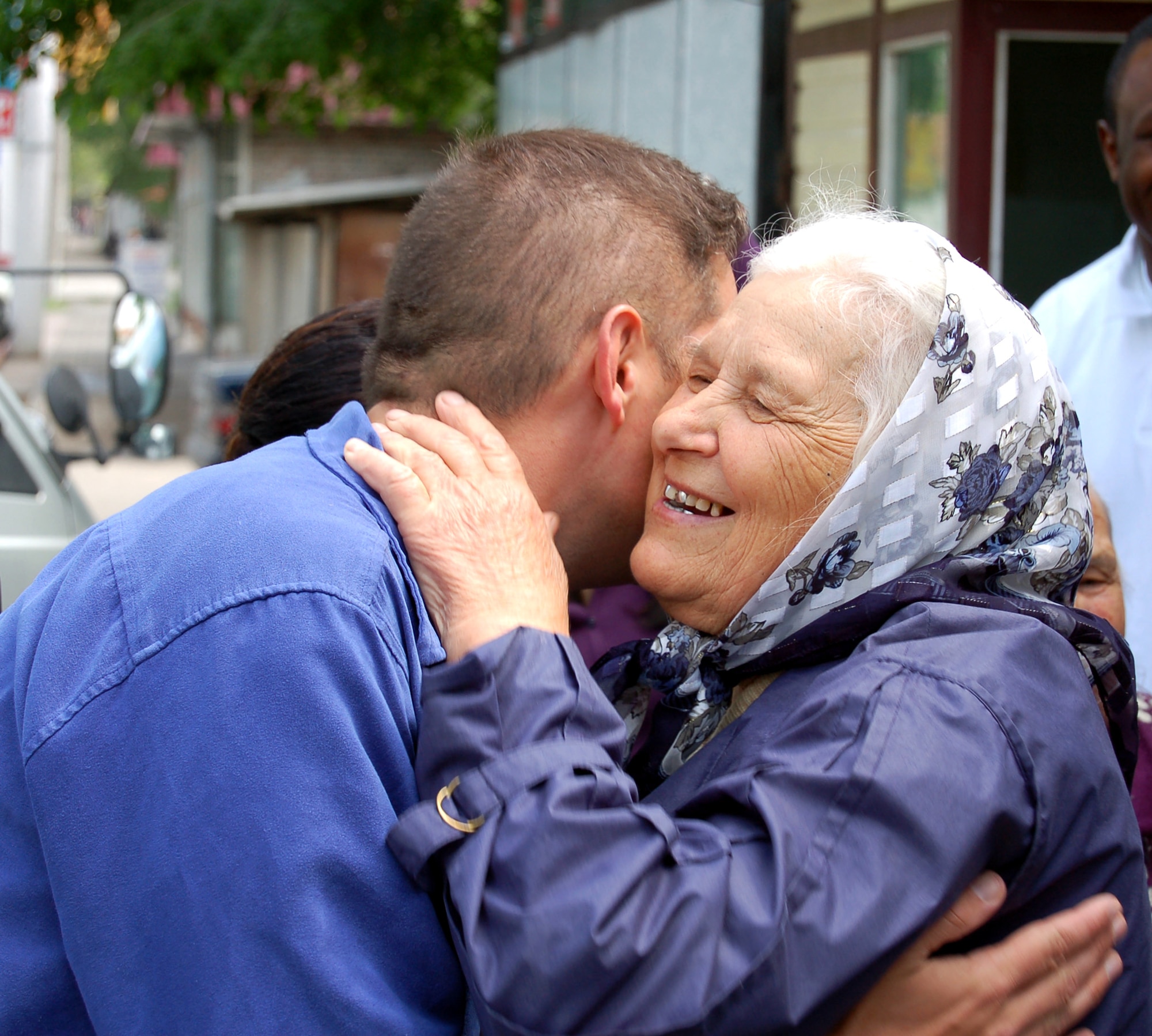 Olga hugs Capt. Arnold Sauve after a lunch outing in Bishkek, Kyrgyzstan, on Thursday, May 4, 2006. Airmen from nearby Manas Air Base sponsor 20 elderly women who receive aid from Babushka Adoption. The local non-governmental organization assists elderly people left vulnerable as this post-Soviet nation works to stabilize its economy. (U.S. Air Force photo/Staff Sgt. Lara Gale)