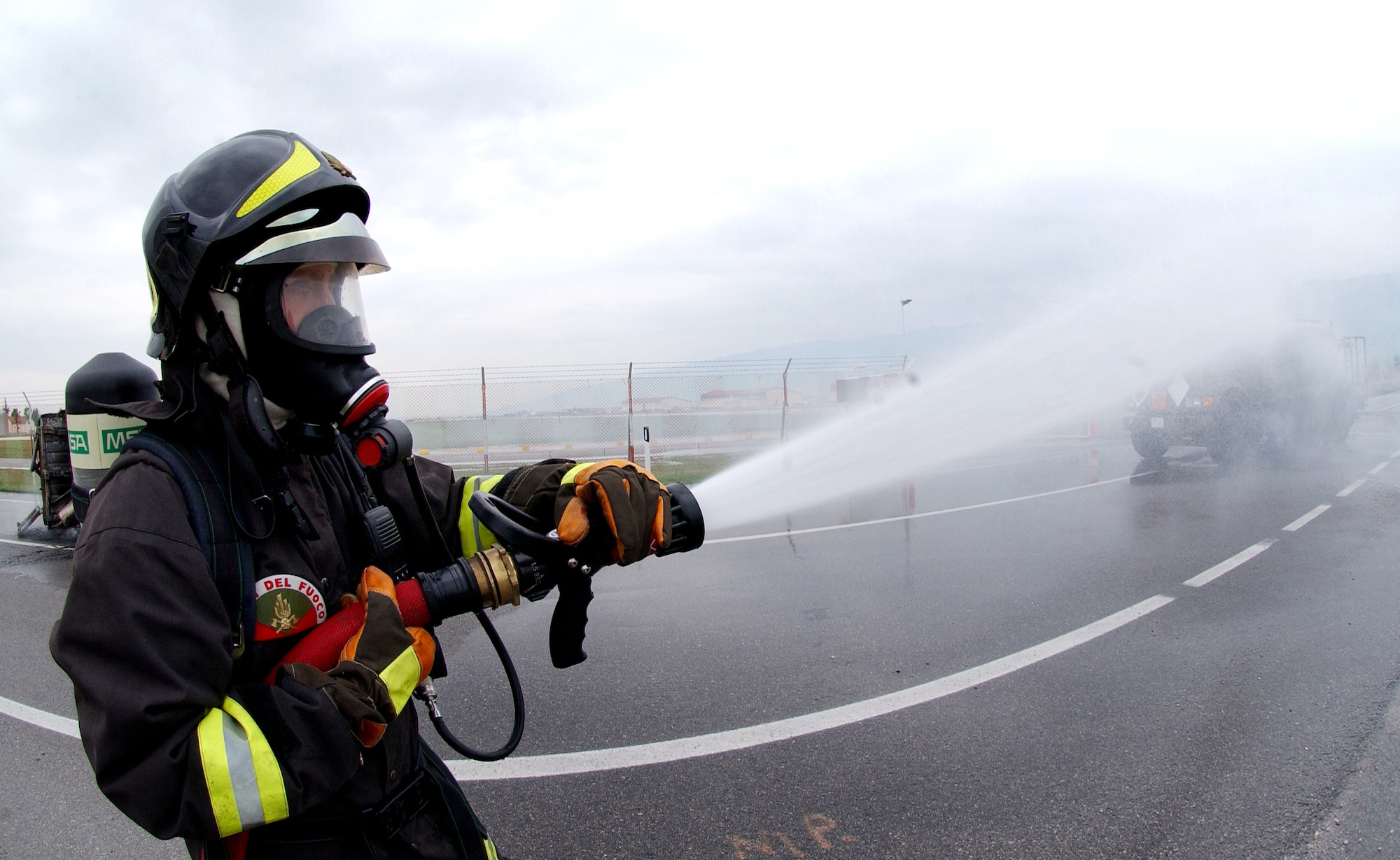 A firefighter from the Vigili del Fuoco (Italian Fire Department) participates in an American-Italian exercise on Thursday, May 4, 2006. Responders from various Italian fire and police departments and medical facilities joined those from the 31st Fighter Wing fire department, hospital and security forces at Aviano Air Base, Italy, for a mass accident exercise. The purpose of the exercise is to develop a seamless response capability between Italian and American emergency professionals. (U.S. Air Force photo/Tech. Sgt. Charlein Sheets) 
