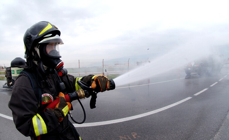 A firefighter from the Vigili del Fuoco (Italian Fire Department) participates in an American-Italian exercise on Thursday, May 4, 2006. Responders from various Italian fire and police departments and medical facilities joined those from the 31st Fighter Wing fire department, hospital and security forces at Aviano Air Base, Italy, for a mass accident exercise. The purpose of the exercise is to develop a seamless response capability between Italian and American emergency professionals. (U.S. Air Force photo/Tech. Sgt. Charlein Sheets) 