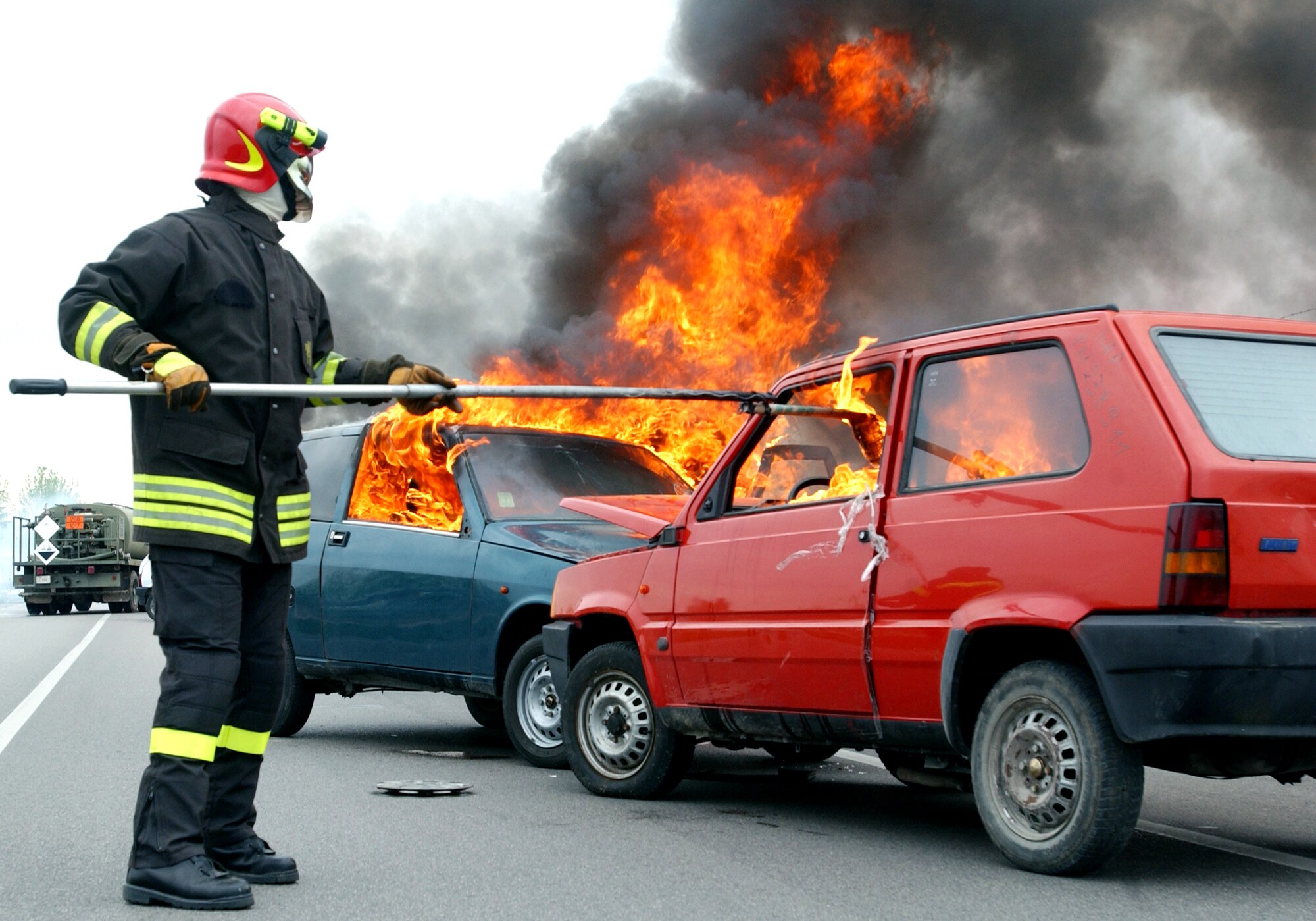 An Italian fireman lights a car on fire for an American-Italian exercise on Thursday, May 4, 2006. Responders from various Italian fire and police departments and medical facilities joined those from the 31st Fighter Wing fire department, hospital and security forces at Aviano Air Base, Italy, for a mass accident exercise. The purpose of the exercise is to develop a seamless response capability between Italian and American emergency professionals. (U.S. Air Force photo/Tech. Sgt. Charlein Sheets)
