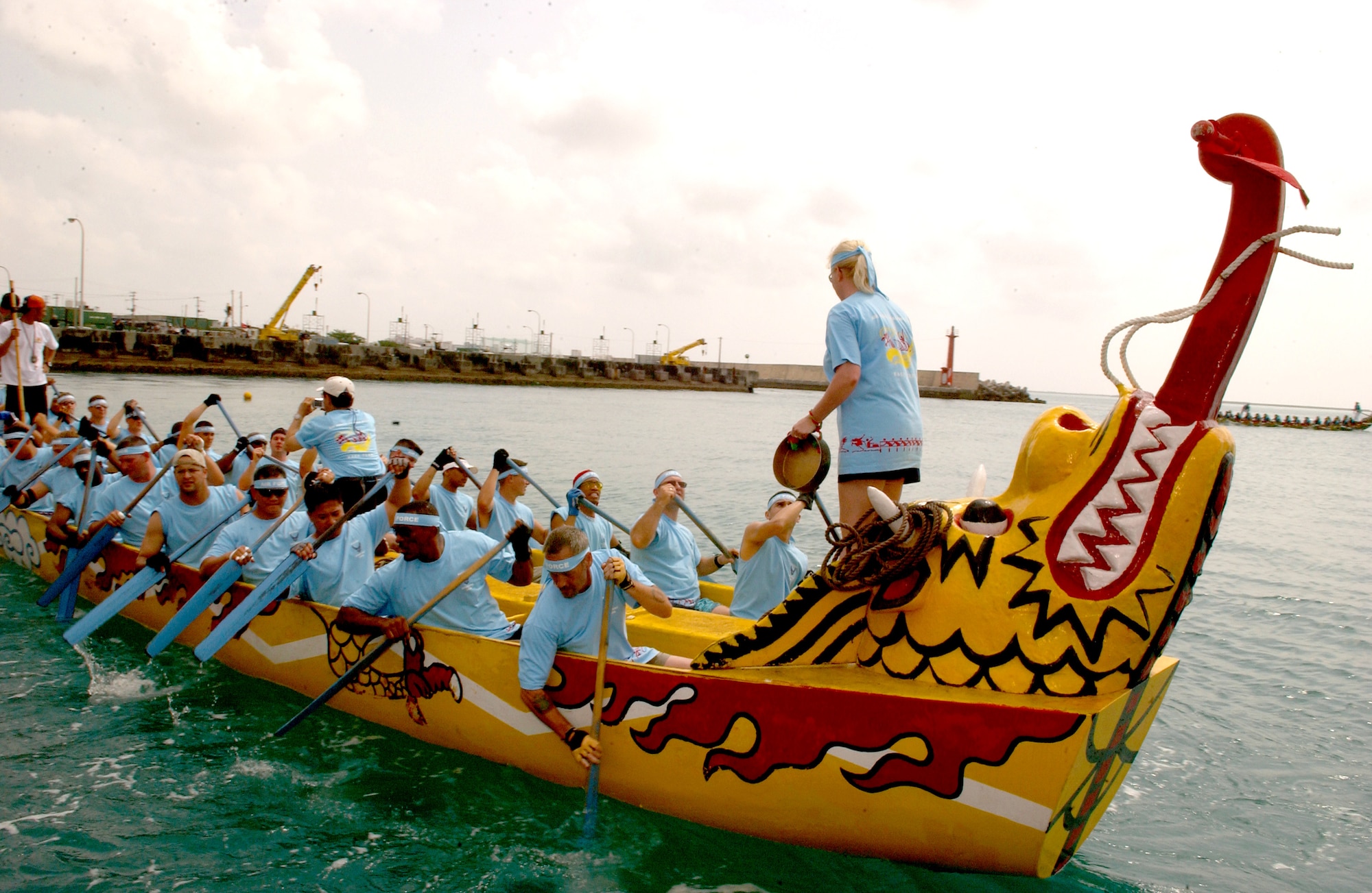 Airmen comprising the "Kadena Shoguns" dragon boat team from Kadena Air Base, Japan, race against two local teams during the 32nd Annual Naha Dragon Boat races at Naha Port, Okinawa, Japan, on Friday, May 5, 2006. More than 60 teams, including eight military teams from U.S. bases on Okinawa, competed in the annual races. Among U.S. military teams, the Air Force finished second at 5:21 minutes in the men's division. In the women's division, the Air Force also finished second at 5:57 minutes. (U.S. Air Force photo/Airman 1st Class Jeremy McGuffin) 
