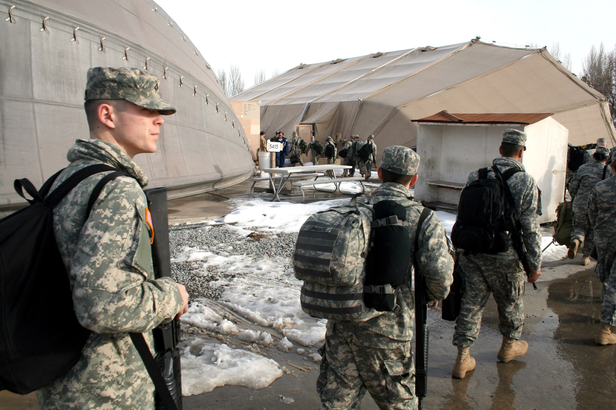 Soldiers file into "clamshells" at Manas Air Base, Kyrgyzstan, where they await transportation to Afghanistan. Record-breaking numbers of servicemembers passed through the base en route to and from Afghanistan over the past four months. The 376th Expeditionary Services Squadron troops were responsible for sheltering and feeding them while running morale and welfare programs for more than 1,000 permanent party on base. (U.S. Air Force photo/Staff Sgt. Lara Gale) 

