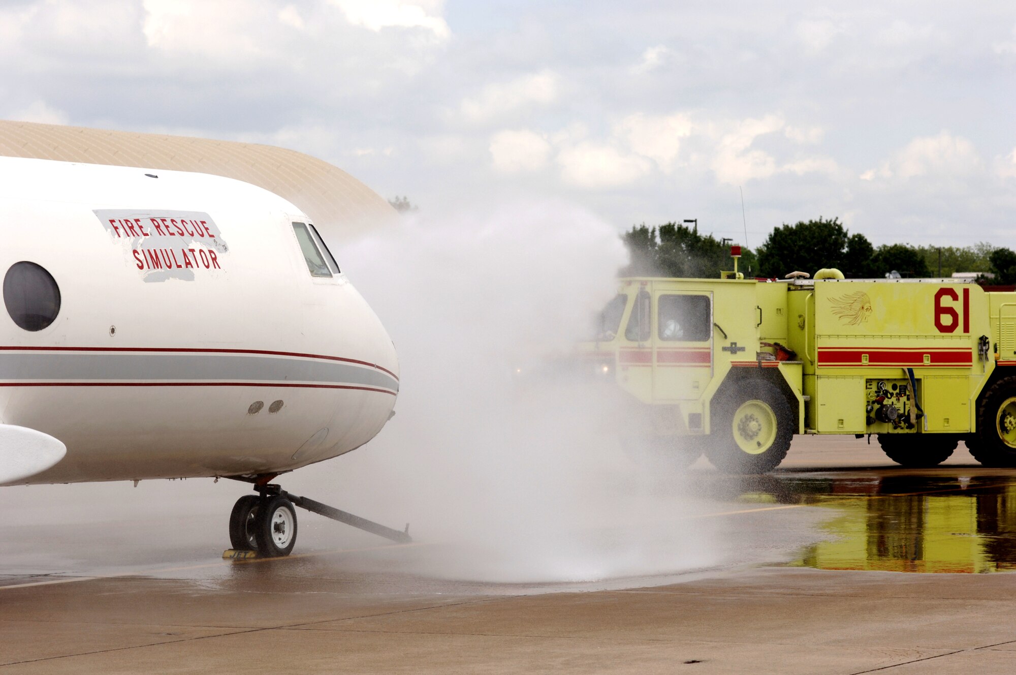 A fire rescue simulator is sprayed by firefighters from the Air National Guard's 138th Civil Engineer Squadron in Tulsa, Okla., on Sunday, May 7, 2006, during a fire training exercise. (U.S. Air Force photo/Master Sgt. Preston Chasteen) 
