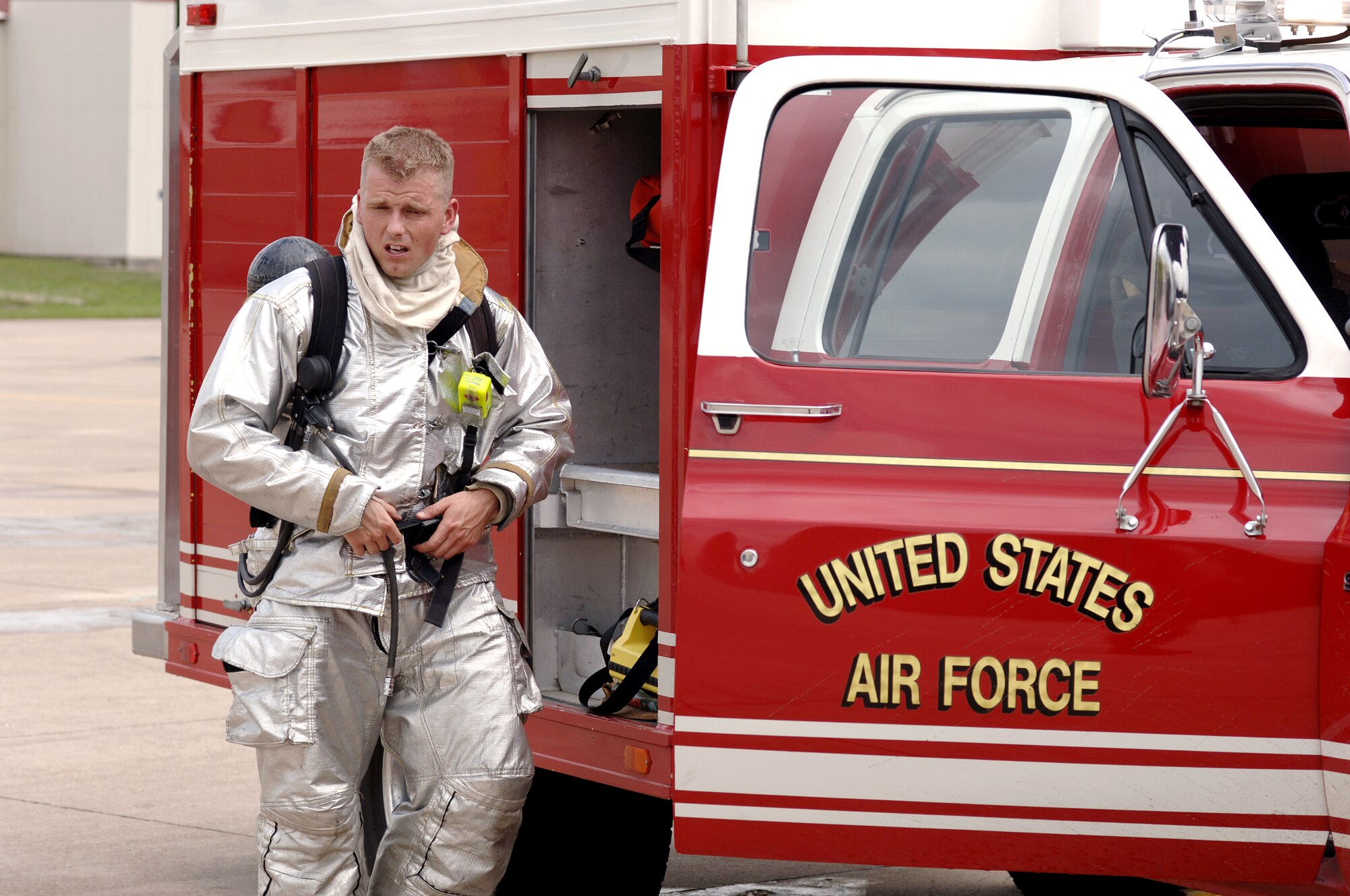 Staff Sgt. Luca Shearer removes his fire protection suit after participating in an aircraft fire exercise on Sunday, May 7, 2006, in Tulsa, Okla. He is assigned to the Air National Guard's 138th Civil Engineer Squadron in Tulsa. (U.S. Air Force photo/Master Sgt. Preston Chasteen) 

