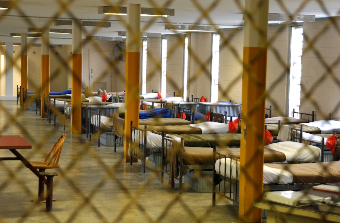 MARINE CORPS BASE CAMP LEJEUNE, N.C. - Without the metal bars on the windows and the chain-link fence blocking the entrance, this squad bay looks almost identical to the ones found at boot camp. Similar to the recruit training experience, the daily lives of prisoners revolve around a strictly regimented schedule of events. There are a total of seven squad bays in the Camp Lejeune Base Brig; each one can hold either a maximum of 24 prisoners or a maximum of 40 prisoners at one time. Photo by:  Lance Cpl. Drew W. Barker