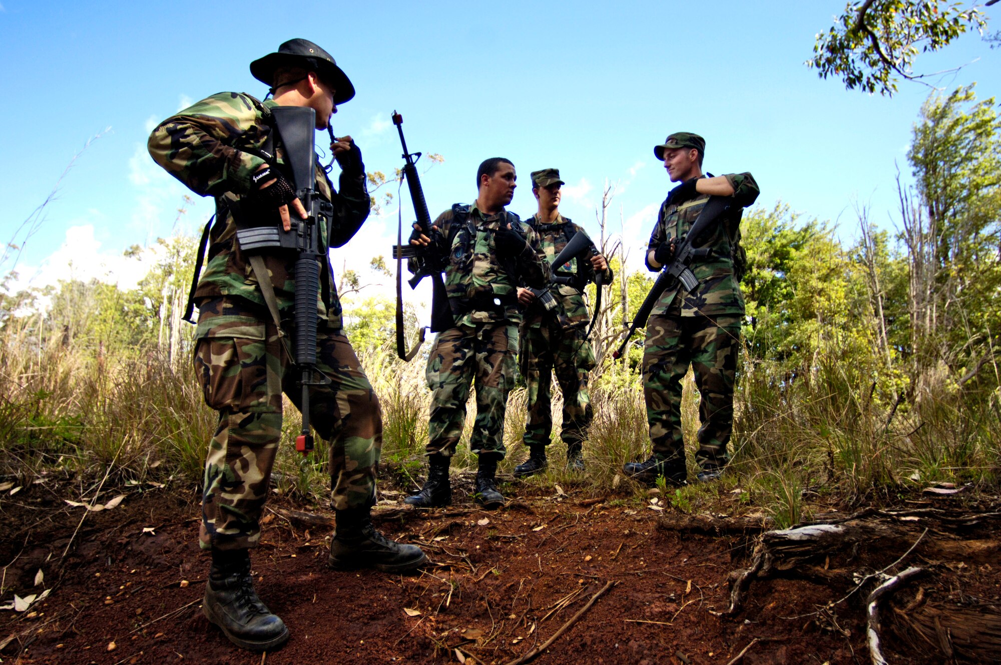 "Aggressors" discuss possible locations to catch students who are going through a ground survival refresher course at Schofield Barracks, Hawaii, on Thursday, May 4, 2006. The course provides realistic training for aircrew members and concentrates on the principles, techniques and skills necessary to survive in any environment. The Airmen are from the 15th Civil Engineer Squadron at Hickam Air Force Base, Hawaii. (U.S. Air Force photo/Tech. Sgt. Shane A. Cuomo)