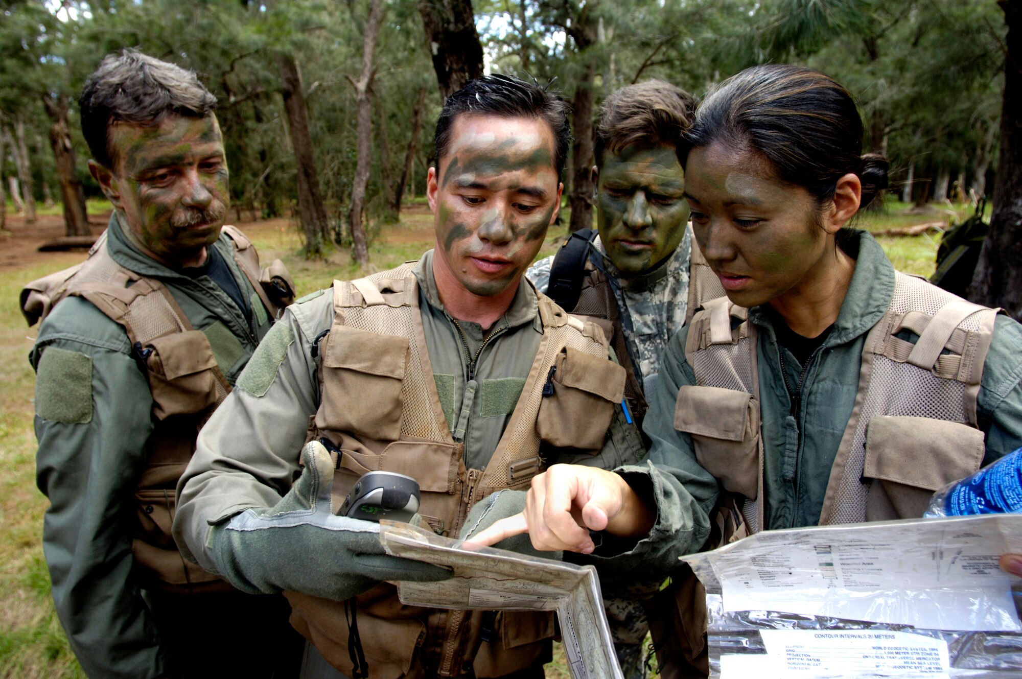 Students use a map and GPS (global positioning system) to find their location May 4, 2006 during a ground survival refresher course at Schofield Barracks training area, Hawaii. The course provides hands on realistic training for aircrew members that concentrates on the principles, techniques, and skills necessary to survive in any environment and return home. Staff Sgt. Ferguson is the SERE (survival, evasion resistance and escape) instructor from the 15th Operations Support Squadron. He is responsible for training all active duty and Air National Guard aircrews on Hickam. (U.S. Air Force photo/Tech. Sgt. Shane A. Cuomo)
