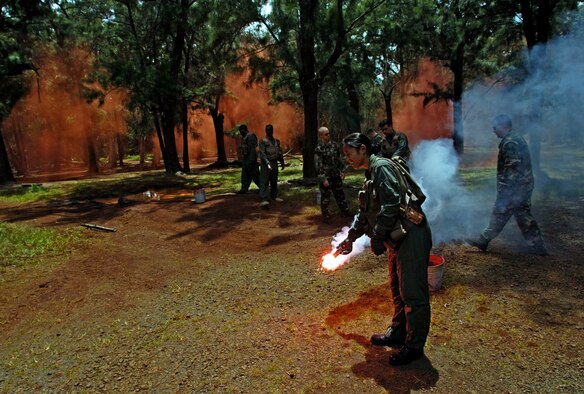 Students practice igniting survival flares during a ground survival refresher course at Schofield Barracks, Hawaii, on Thursday, May 4, 2006. The course provides realistic training for aircrew members and concentrates on the principles, techniques and skills necessary to survive in any environment. (U.S. Air Force photo/Tech. Sgt. Shane A. Cuomo)