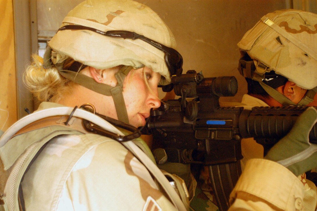 Airman 1st Class Erika Asbury takes aim with an M-4 rifle as part of training at an Army training facility at Bagram Air Base, Afghanistan, on Tuesday, May 9, 2006. The Military Operations in Urban Terrain facility is a replica of an Afghan village, used to train Airmen and Soldiers in dealing with enemy forces in close quarters. Airman Asbury is deployed to the 455th Expeditionary Security Forces Squadron from Eglin Air Force Base, Fla. (U.S. Air Force photo/Maj. David Kurle)