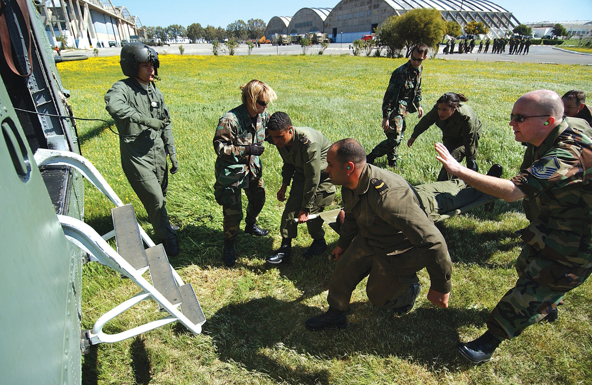 Tunisian and U.S. military medical personnel load a stretcher onto a waiting Tunisian helicopter during a mass casualty exercise for MEDLITE 2006 at  Kharrouba Air Base in Bizerte, Tunisia. MEDLITE 2006 provides an exchange of medical skills, techniques and procedures between US Air Force medical service personnel and the Tunisian Military Health Services. More specifically, the mission is to conduct deployment, employment, and redeployment exercise phases. Approximately 220 to 250 Tunisian and 75 U.S. military medical personnel, including 446th Airlift Wing doctors, nurses, and medical technicians, participated in the exercise. USAF photo by Tech. Sgt. Rick Sforza/4th Combat Camera Squadron
