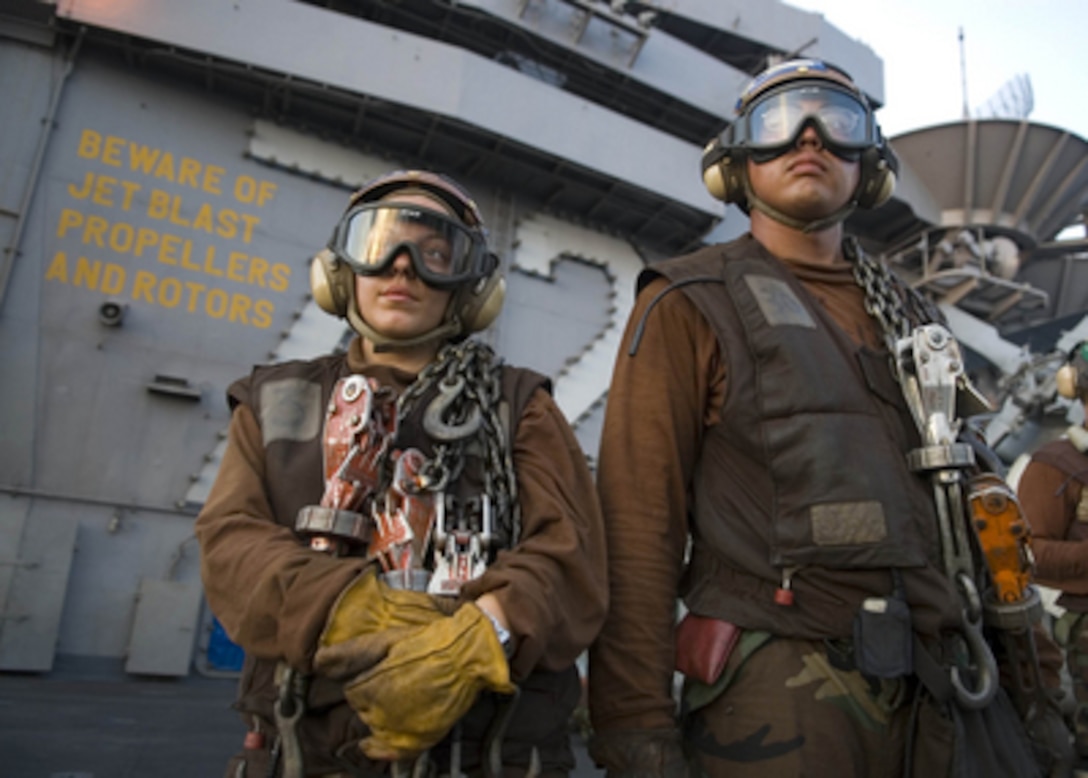 U.S. Navy plane captains stand by as their aircraft are launched during flight operations onboard the aircraft carrier USS Abraham Lincoln (CVN-72) on May 6, 2006. The Lincoln and embarked Carrier Air Wing 2 are operating in the South China Sea. 