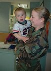 Staff Sgt. Sheena Hansen, 5th Maintenance Group, picks up her son Rylee at the Child Development Center Tuesday. (Air Force photo by Senior Airman Danny Monahan)