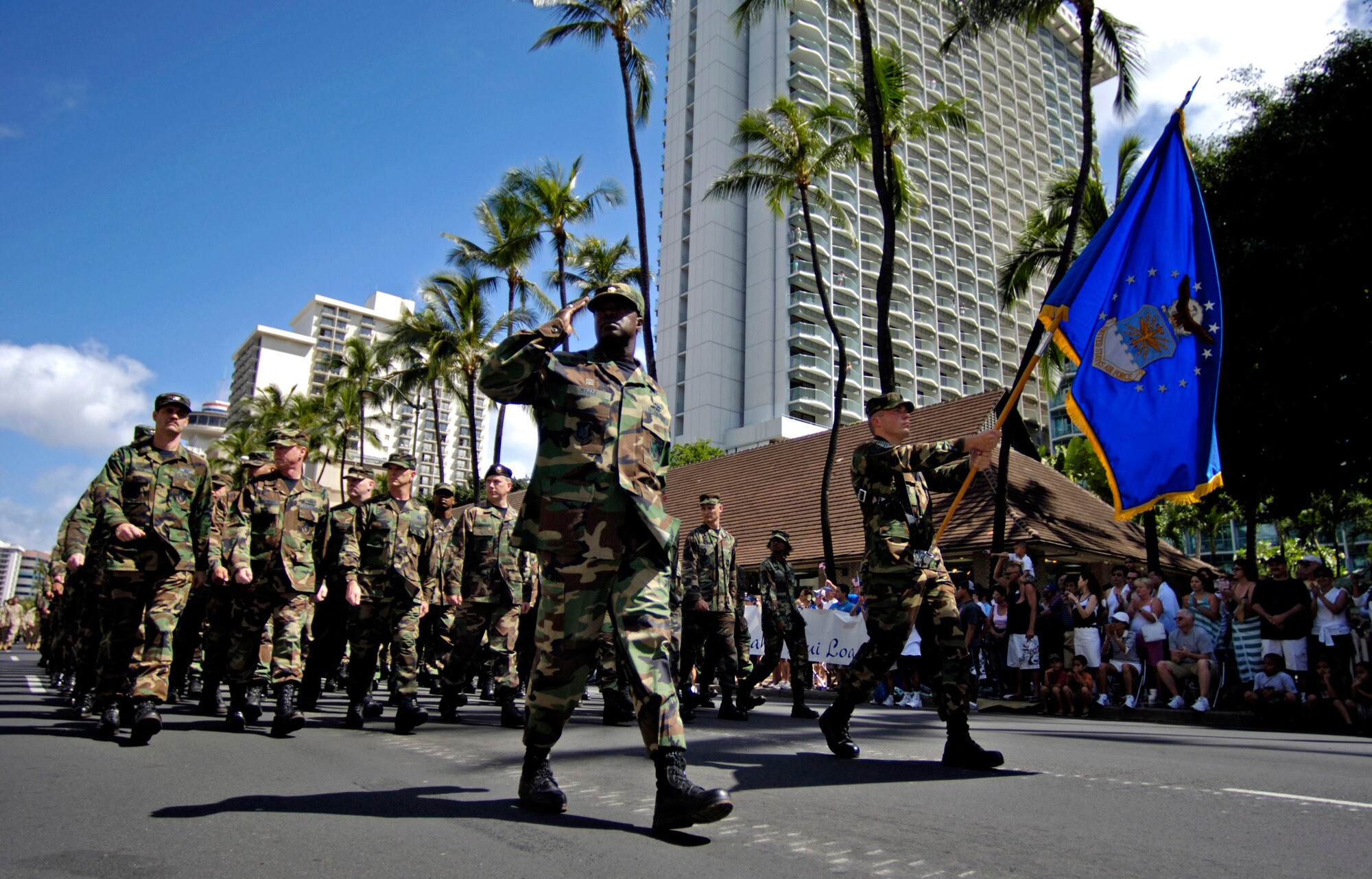 Airmen from Hickam Air Force Base, Hawaii, march past the review stand during the "Salute to our Troops" parade in downtown Honolulu on Saturday, May 6, 2006. The USO hosted the parade which included active-duty, Guard and Reserve members of all the services. (U.S. Air Force photo/Tech. Sgt. Shane A. Cuomo) 
