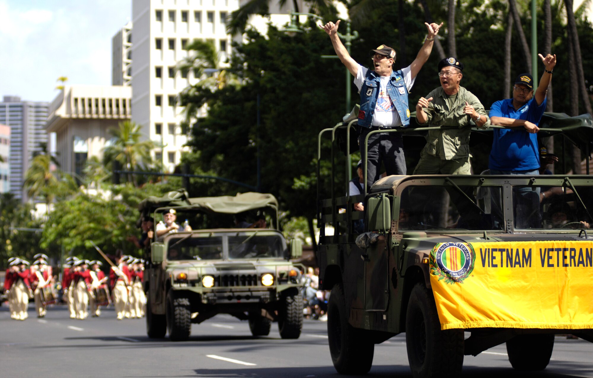 Vietnam veterans wave to the crowd during the "Salute to our Troops" parade in downtown Honolulu on Saturday, May 6, 2006. The USO hosted the parade which included active-duty, Guard and Reserve members of all the services. (U.S. Air Force photo/Tech. Sgt. Shane A. Cuomo) 
