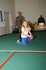 Master Sgt. Tina Schneider, 5th Maintenance Group, watches her daughter, Sierra during baseball practice at the David C. Jones Youth Center Wednesday. (Air Force photo by Staff Sgt. Jocelyn Rich.)

