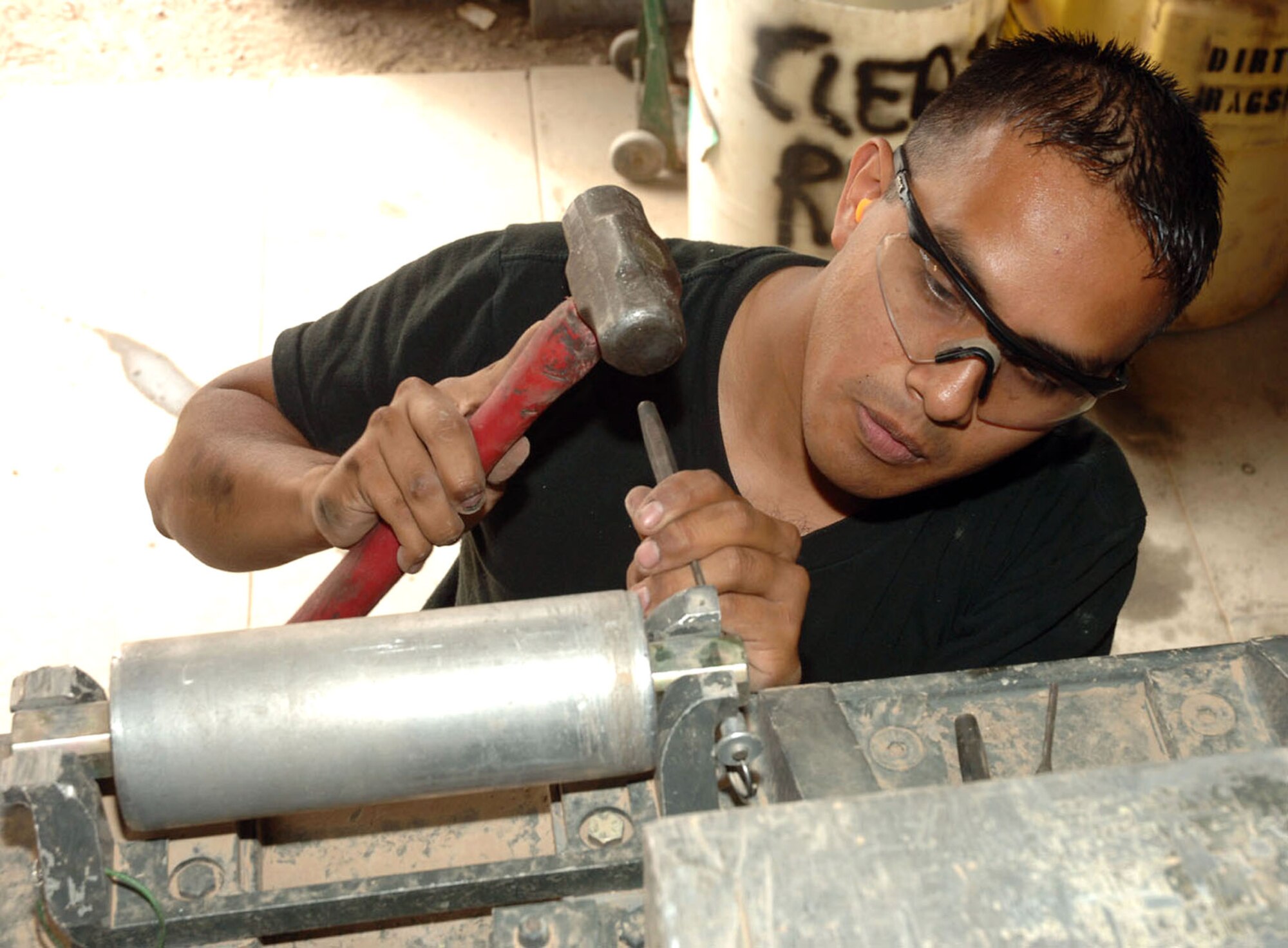 Senior Airman Jorge Chavez removes a roller on a K-loader at Sather Air Base, Iraq, on Monday, May 1, 2006. He is a mechanic with the 447th Expeditionary Logistics Readiness Squadron vehicle maintenance flight. (U.S. Air Force photo/Master Sgt. Will Ackerman)
