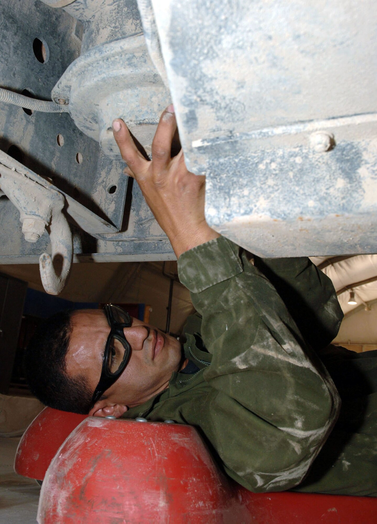 Staff Sgt. Oscar Figueroa works on a bus at Sather Air Base, Iraq, on Monday, May 1, 2006. He is a mechanic with the 447th Expeditionary Logistics Readiness Squadron vehicle maintenance flight. (U.S. Air Force photo/Master Sgt. Will Ackerman)

