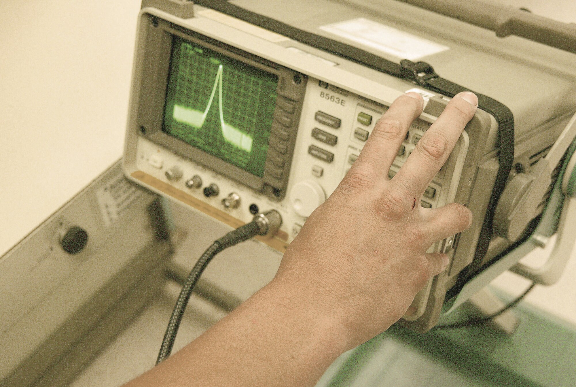 A PMEL technician prepares an oscilloscope to take measurements to calibrate test equipment.  (U.S. Air Force Photo/Senior Airman John Gordinier)