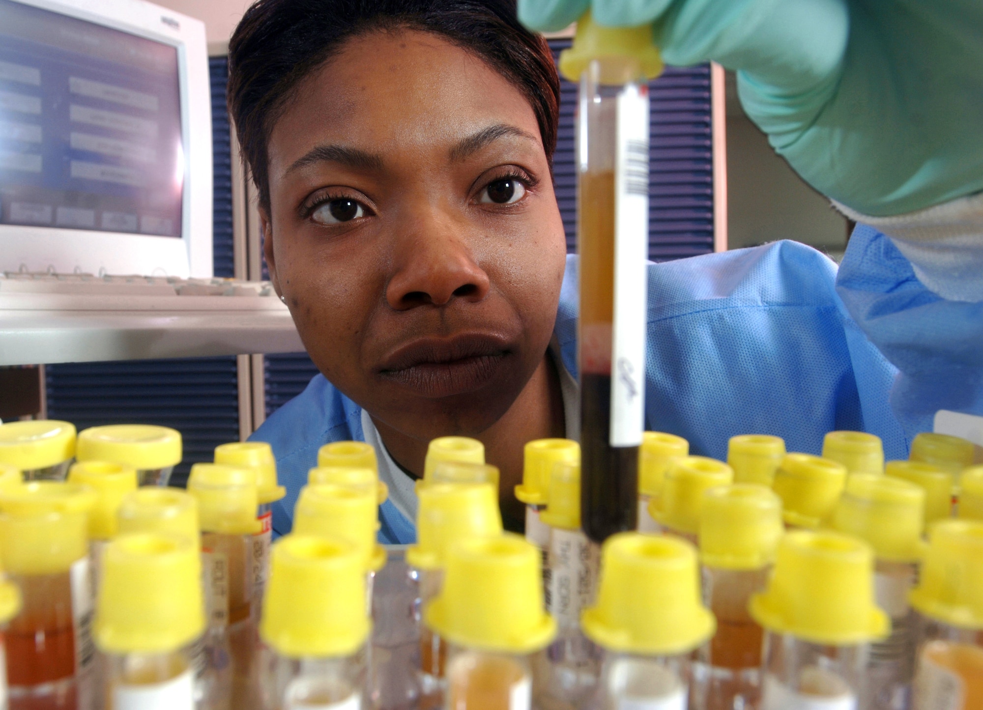 Senior Airman Shavone Simmons checks specimens before running a test at Yokota Air Base, Japan, on Thursday, May 11, 2006. Airman Simmons is a medical laboratory technician with the 374th Medical Group. Her laboratory performs more than 48,000 tests annually. (U.S. Air Force photo/Val Gempis) 
