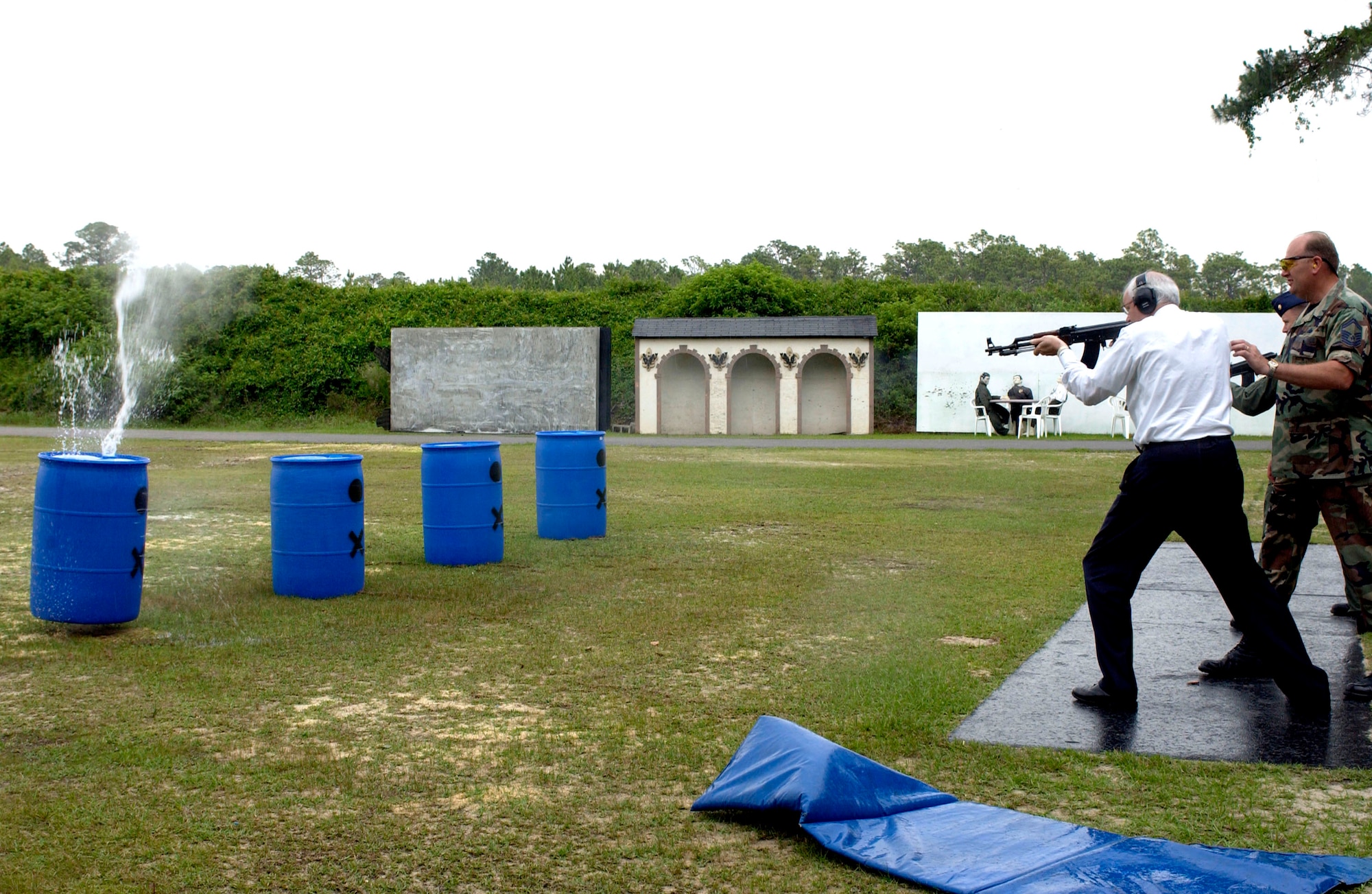 Secretary of the Air Force Michael W. Wynne fires an AK-47 assault rifle at a water-filled target at the Air Force Special Operations School at Hurlburt Field, Fla., on Tuesday, May 9, 2006.  Senior Master Sgt. Steven Moore watches for safety and proper use of the weapon . Sergeant Moore is with the asymmetric warfare division at the school. (U.S. Air Force photo/Staff Sgt. Orly N. Tyrell)
