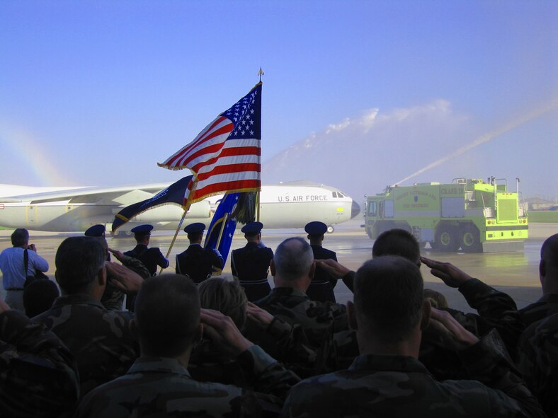 WRIGHT-PATTERSON AIR FORCE BASE, Ohio -- Reservists from the 445th Airlift Wing salute the last operational C-141 known as the Hanoi Taxi as it goes through an arch of water on the apron as it taxies out for its last take-off on May 6, 2006 heading for the National Museum on the United States Air Force.  (U.S. photo by Capt. Doug Sellars)