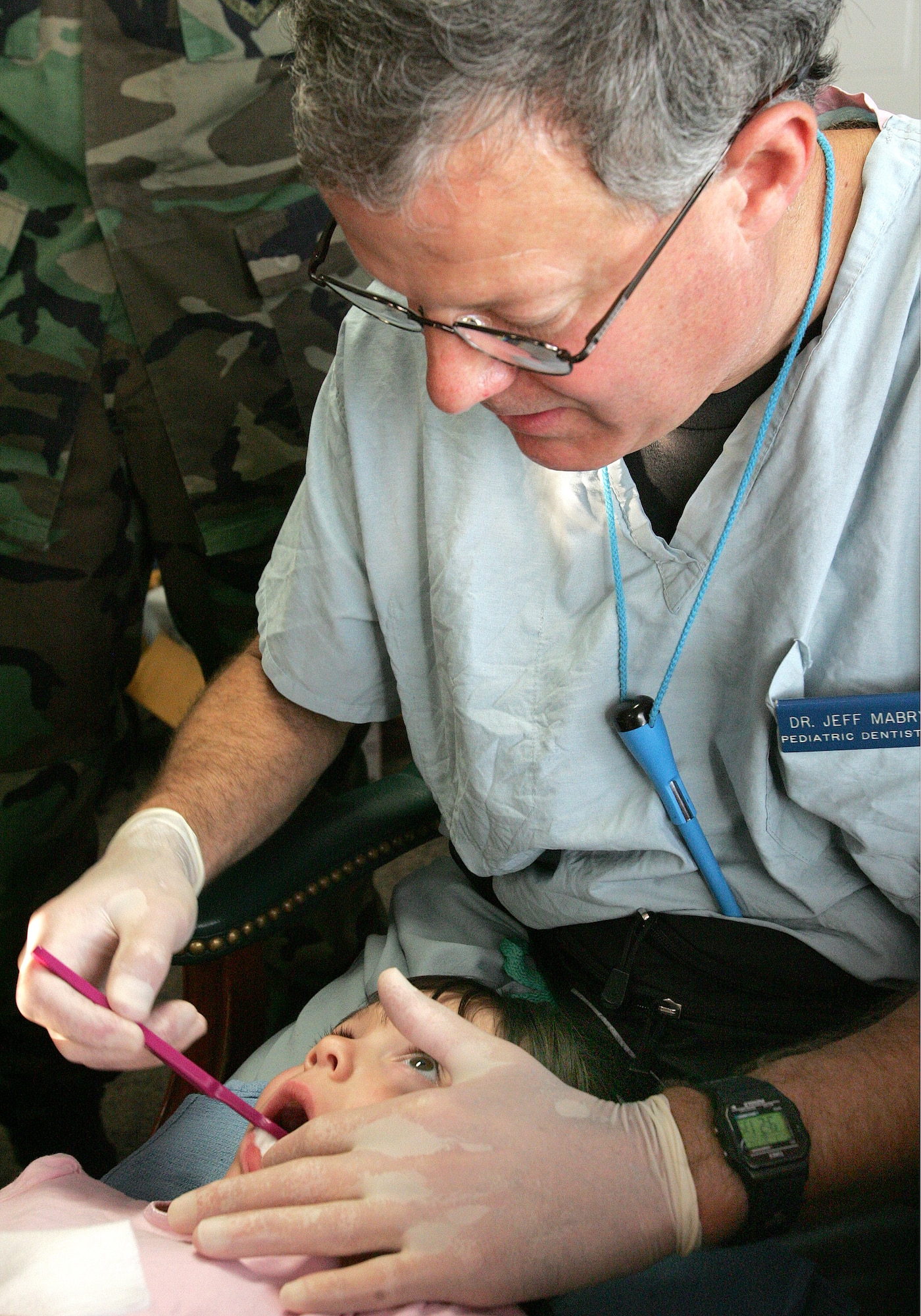 Madison Bellon opens wide while Col. (Dr.) Jeffery Mabry brushes her teeth at the Skylark Community Center at Lackland Air Force Base, Texas, on Wednesday, May 10, 2006. The pediatric dental department at Lackland provides drop-in dental screenings as part of their pediatric dental training program. Colonel Mabry is director of pediatric dentistry with the 59th Dental Squadron. (U.S. Air Force photo/Robbin Cresswell)