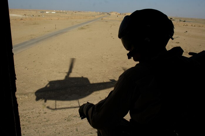 Cpl. Curtis R. Ingersoll looks out the side of a UH-1N Huey helicopter on the return flight from a dismounted patrol escort flight over Karma, Iraq, May 11. Ingersoll is a crew chief and West Bend, Wis., native deployed with Marine Light Attack Helicopter Squadron 169, Marine Aircraft Group 16 (Reinforced), 3rd Marine Aircraft Wing.