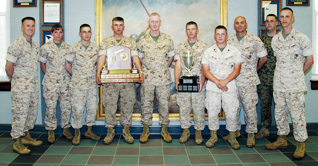 The Parris Island Rifle and Pistol Team show off their new trophies to Brig. Gen. Richard T. Tryon, commanding general, MCRD Parris Island/Eastern Recruiting Region, at Barrow Hall May 12.