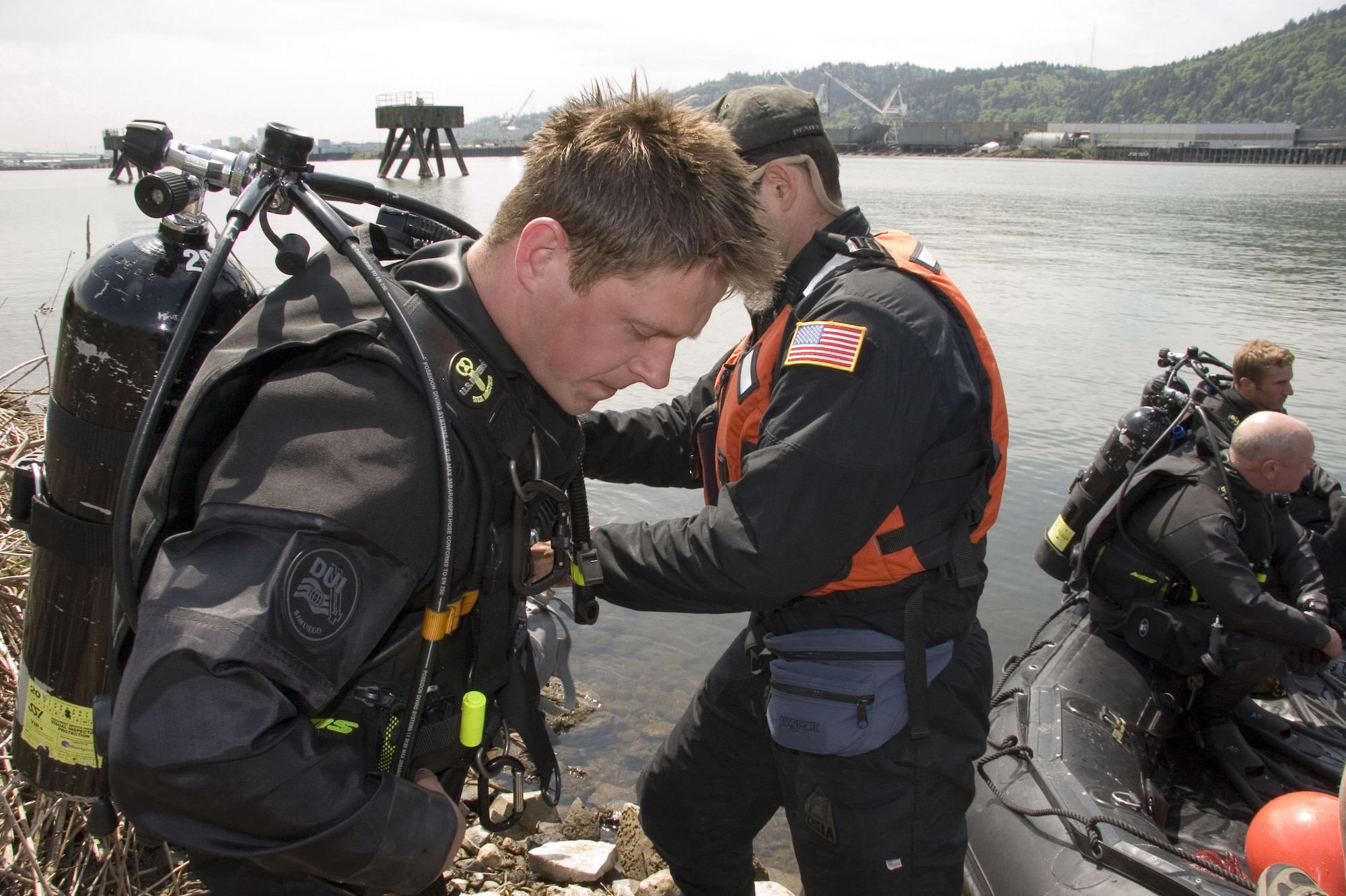 Staff Sgt. Chris Uriarte, 306th Rescue Squadron pararescueman has his scuba gear inspected before he practices underwater hazardous device searches at a hull of a ship docked at Swan Island, Ore. May 11, 2006. (U.S. Air Force Photo/Ruby Zarzyczny)