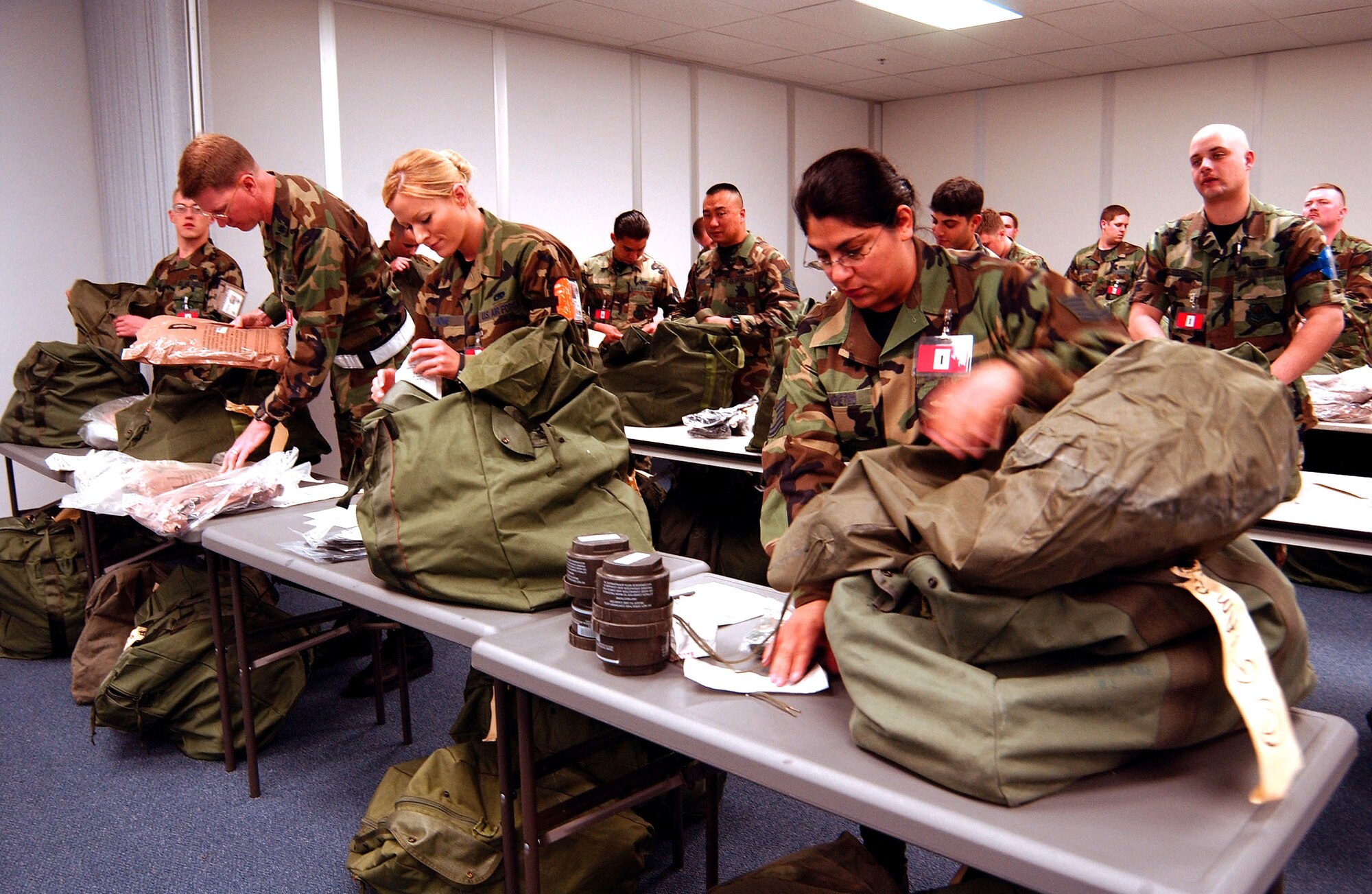 Airmen from McChord Air Force Base, Wash., go through their mobility bags to make sure they have the items they will need for their "deployment" to Exercise Thunderbolt at Alpena, Mich., on Saturday, May 6, 2006. More than 650 Airmen from the 62nd and 446th Airlift Wings at McChord joined 425 Airmen from Grand Forks Air Base, N.D., for the mobility exercise. (U.S. Air Force photo/Kevin Tosh Jr.)