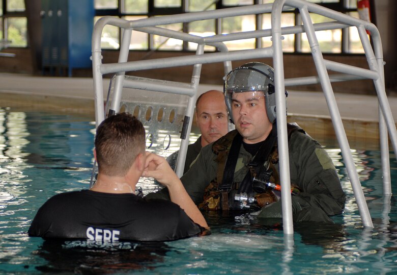 Capt. Michael Garner prepares to be rolled underwater while harnessed inside a cage at Moody Air Force Base, Ga., on Friday, May 5, 2006. The water survival training simulates the actions an aircrew member must take to safely escape if his or her aircraft crashes into the water. Captain Garner is with the 41st Rescue Squadron. (U.S. Air Force photo/Senior Airman Joshua Jasper)