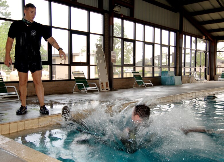 Tech. Sgt. Teddy Allison watches as Capt. Christian Barnes is pulled by a harness during water survival training at Moody Air Force Base, Ga., on Friday, May 5, 2006. Captain Barnes tried to remove the harness while being dragged through the water, simulating the effects of the wind when jumping into the ocean. Sergeant Allison is a survival, evasion, resistance and escape instructor with the 347th Operations Support Squadron; Captain Barnes is with the 71st Rescue Squadron. (U.S. Air Force photo/Senior Airman Joshua Jasper)