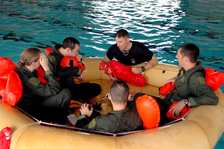 Tech. Sgt. Teddy Allison instructs 71st Rescue Squadron aircrew members on the assembly of a life-raft cover during water survival training at Moody Air Force Base, Ga., on Friday, May 5, 2006. In the case of an aircraft emergency over water, the cover provides protection from wind and rain and acts as a signaling device because of its bright color. Sergeant Allison is a survival, evasion, resistance and escape instructor with the 347th Operations Support Squadron. (U.S. Air Force photo/Senior Airman Joshua Jasper)
