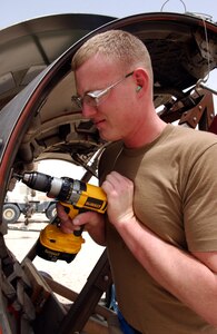 Senior Airman Benjamin Carter drills out a fastener on the thrust reverser door of a C-17 Globemaster III at a desert base on Tuesday, May 2, 2006.  Airman Carter is a sheet metal technician deployed to the 379th Expeditionary Maintenance Squadron from Charleston Air Force Base, S.C. (U.S. Air Force photo/Senior Airman Rachel Walters) 
