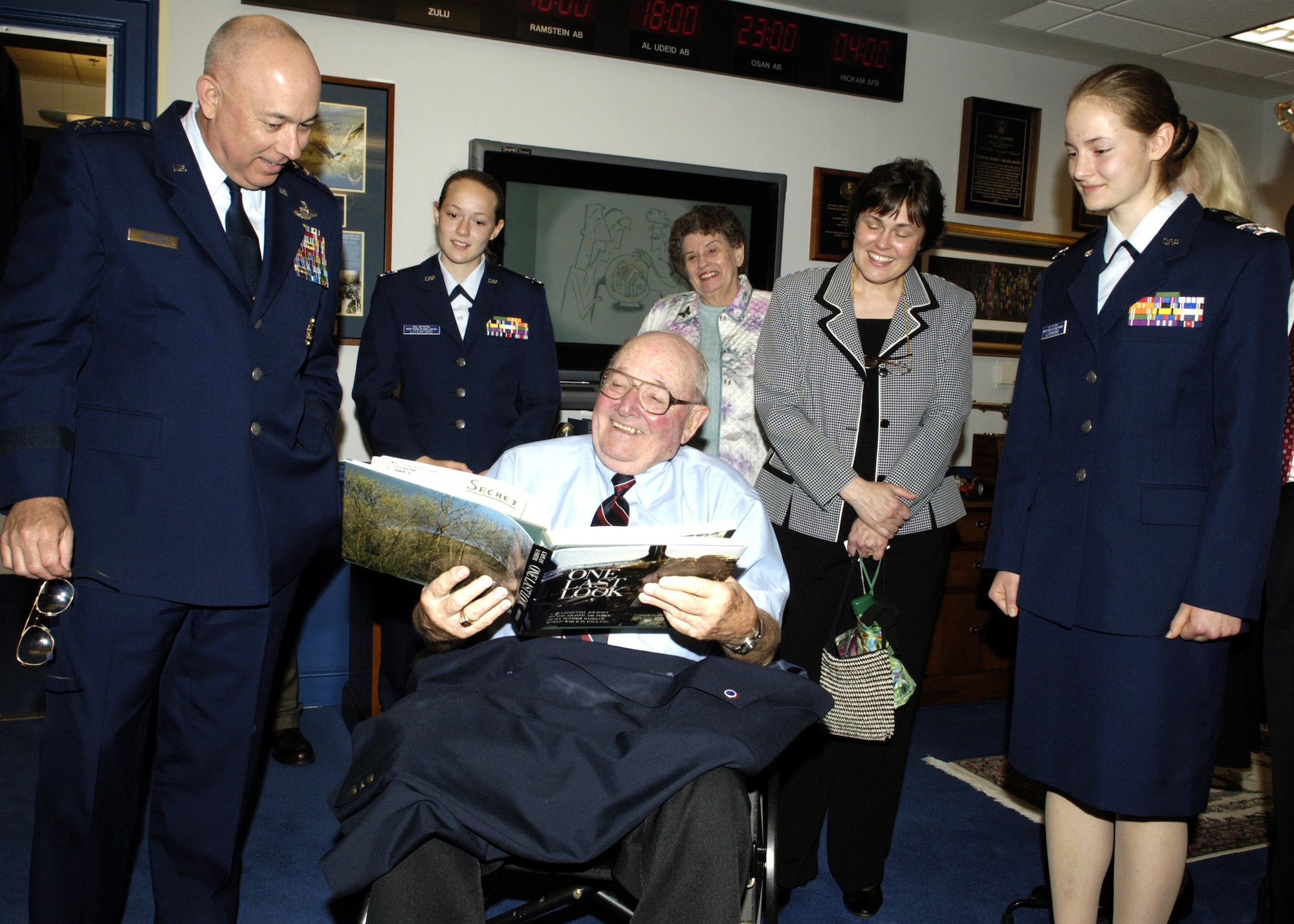 Civil Air Patrol Cadet Col. Katrina Litchford (right) and Air Force Chief of Staff Gen. T. Michael Moseley listen as Cadet Litchford's grandfather James Litchford Sr. shares an anecdote about flying B-17 bombers in WWII under the command of Gen. Carl A. Spaatz. General Moseley had just presented the Gen. Carl A. Spaatz Award to Cadet Litchford during a ceremony in the Pentagon on Thursday, May 11, 2006. Observing are Cadet Litchford's sister, Dominique, also a CAP cadet, and other family members.  (U.S. Air Force photo/Donna Parry)