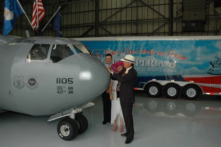 Senior Master Sgt. Robin Taylor, a reservist assigned to the 315th Airlift Wing at Charleston AFB, S.C., and Ronald "Panama" Huskey (center) sign their marriage license on the nose of the "Spirit of Hope, Liberty and Freedom", the miniature C-17 replica.  Chaplian (Maj.) John Painter (behind) married the couple in front of the miniature C-17 replica.  The wedding was originally planned to be help at Charleston AFB's Heritage Park and was moved in front of the Miniature C-17 because of rain.  (Photo by 1st Lt. Wayne Capps, USAFR)