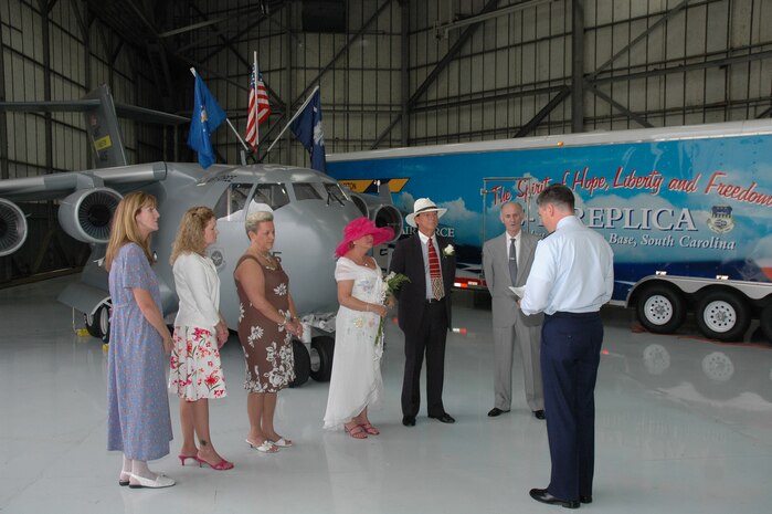 Senior Master Sgt. Robin Taylor, a reservist assigned to the 315th Airlift Wing at Charleston AFB, S.C., and Ronald "Panama" Huskey (center) get married by Chaplain (Maj.) John Painter in front of the "Spirit of Hope, Liberty and Freedom", the miniature C-17 replica.  The wedding was originally planned to be help at Charleston AFB's Heritage Park and was moved in front of the Miniature C-17 because of rain.  (Photo by 1st Lt. Wayne Capps, USAFR)