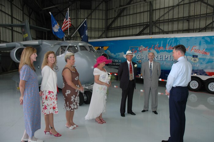 Senior Master Sgt. Robin Taylor, a reservist assigned to the 315th Airlift Wing at Charleston AFB, S.C., and Ronald "Panama" Huskey (center) get married by Chaplain (Maj.) John Painter in front of the "Spirit of Hope, Liberty and Freedom", the miniature C-17 replica.  The wedding was originally planned to be help at Charleston AFB's Heritage Park and was moved in front of the Miniature C-17 because of rain.  (Photo by 1st Lt. Wayne Capps, USAFR)
