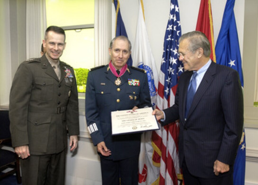 Secretary of Defense Donald H. Rumsfeld (right) presents the Legion of Merit (Degree of Commander) medal to Mexican Minister of Defense Gen. Gerardo Ricardo Vega (center) in the Pentagon on May 12, 2006. Joining Rumsfeld for the presentation is Chairman of the Joint Chiefs of Staff Gen. Peter Pace (left), U.S. Marine Corps. 