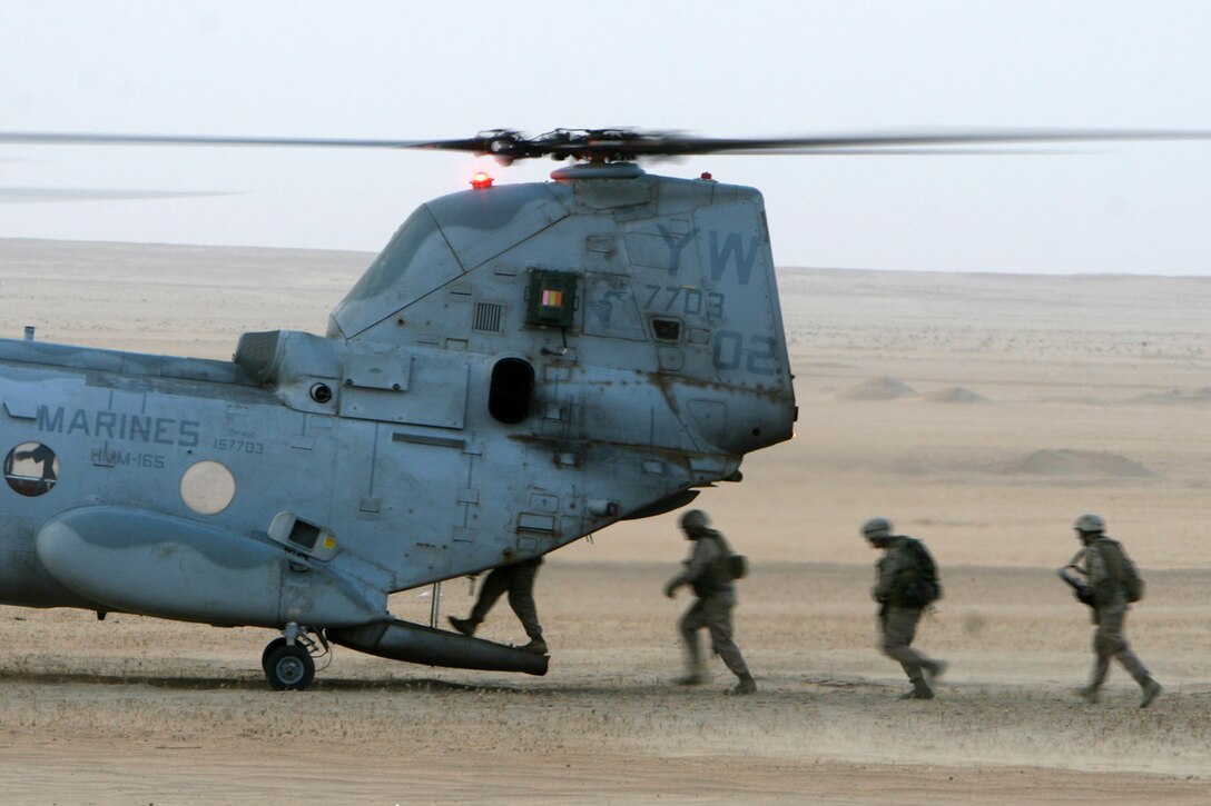 -- Marines with Golf Company, Battalion Landing Team 2/5, 15th Marine Expeditionary Unit load on to a CH-46E Sea Knight from Marine Medium Helicopter Squadron-165, 15th MEU outside Camp Buehring, Kuwait. ::r::::n::   The Camp Pendleton, Calif. based 15th