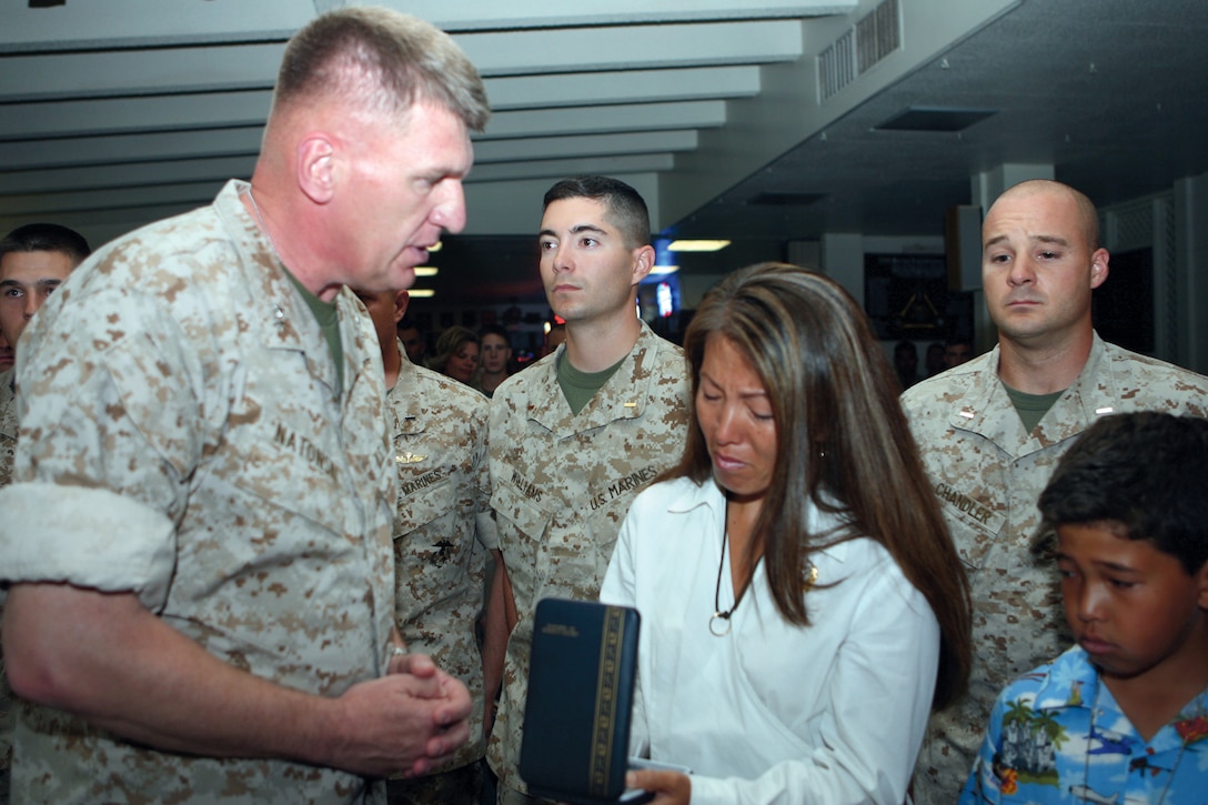 Karen J. Mendoza, wife of Maj. Ramon J. Mendoza, Jr., receives a posthumous Bronze Star Medal from Maj. Gen. Richard F. Natonski, commanding general, 1st Marine Division. About 100 Marines and Sailors attended the ceremony held at Sharky's in Camp Del Mar Friday.